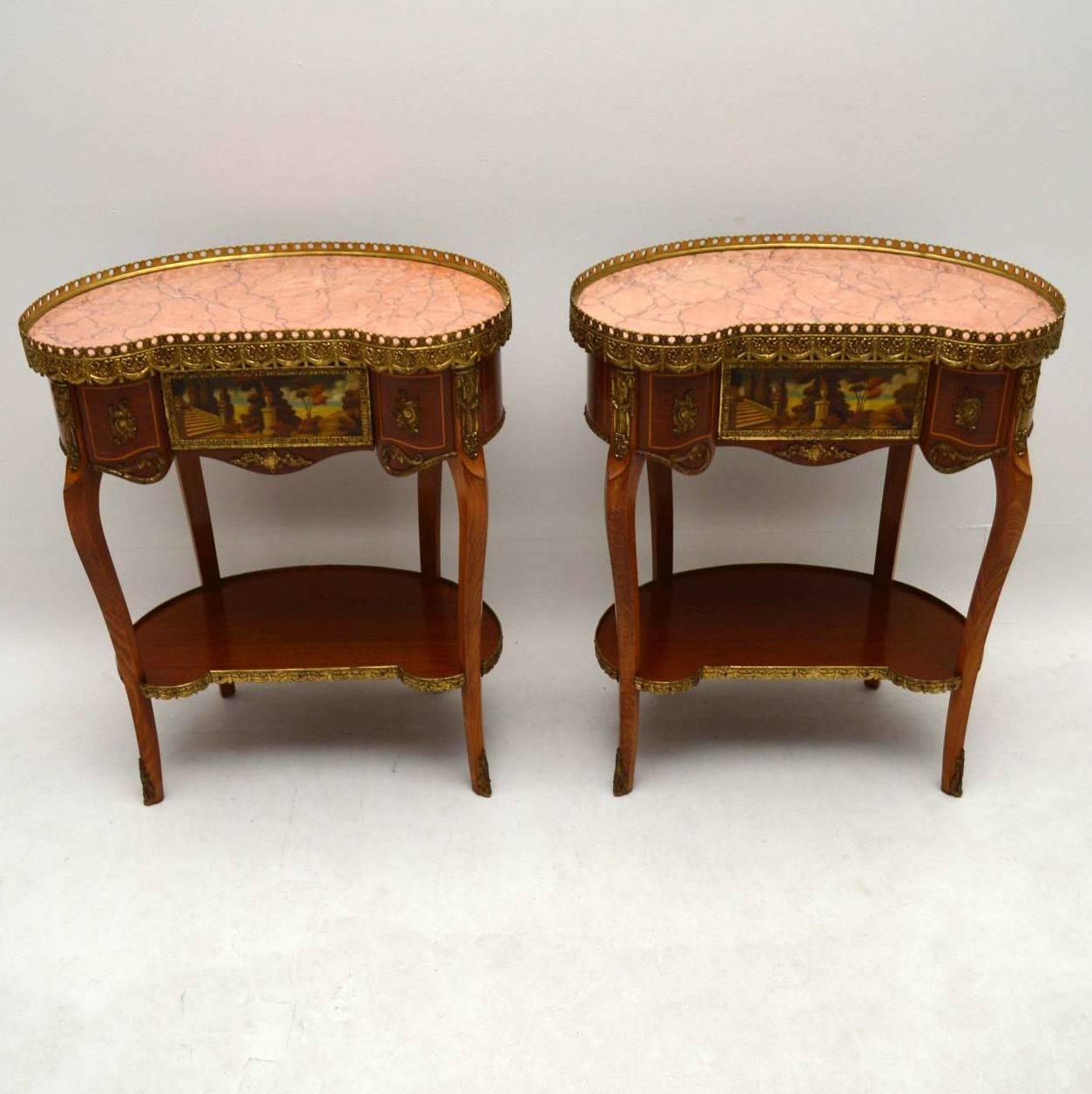 Pair of antique French style marble-top side tables in great condition and dating to around the 1950s period. They are kidney shaped, with gilt metal galleries, mounts, handles and feet. These tables are beautifully decorated all over and have