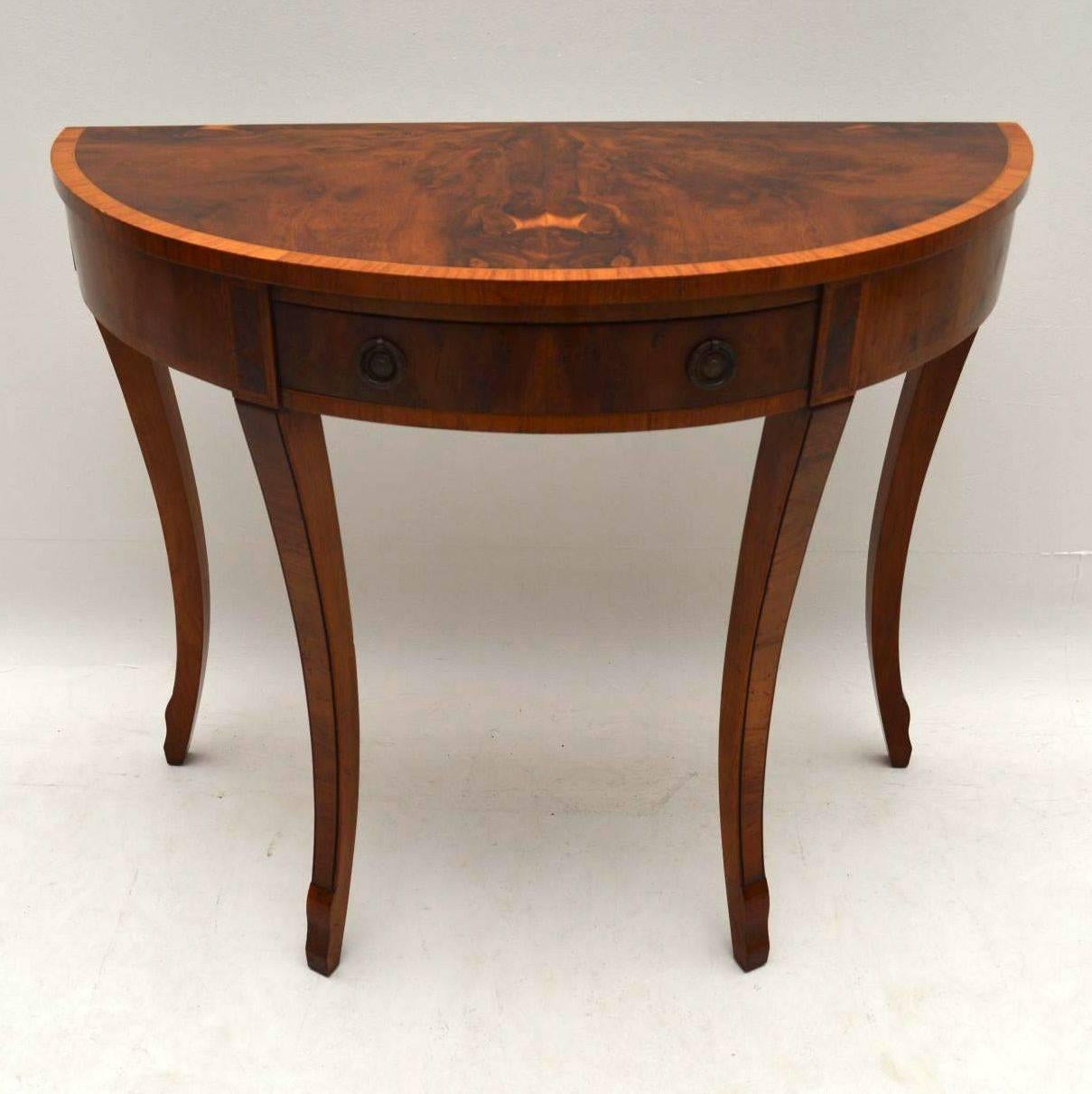 Antique yew wood console side table in excellent condition and dating from circa 1930-1950s period. The pattern in the veneers are beautiful & so is the color. The top has a lovely segmented pattern & also has a satinwood crossbanded edge. There is
