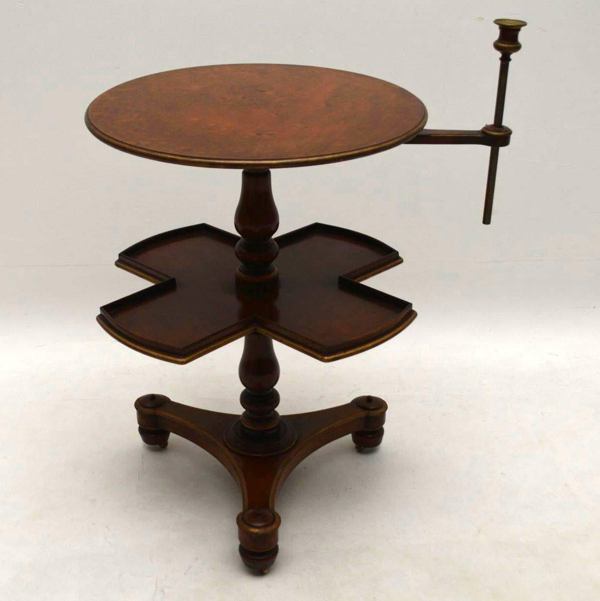 Very unusual antique multifunctional occasional table in walnut with a rotating section below the round top. It dates to around the 1840s period and is in excellent original condition. It has a platform base with casters underneath. The is a gilt