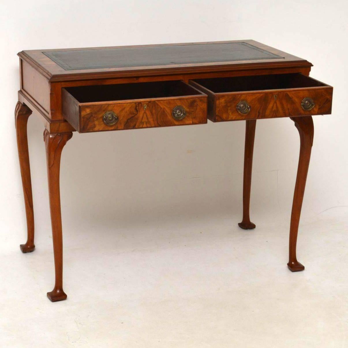 This antique walnut writing table or desk is fabulous quality & has some fine details. It’s in excellent condition & I would date this desk to around the 1910 period. It has a tooled leather writing surface, flanked by burr walnut & a