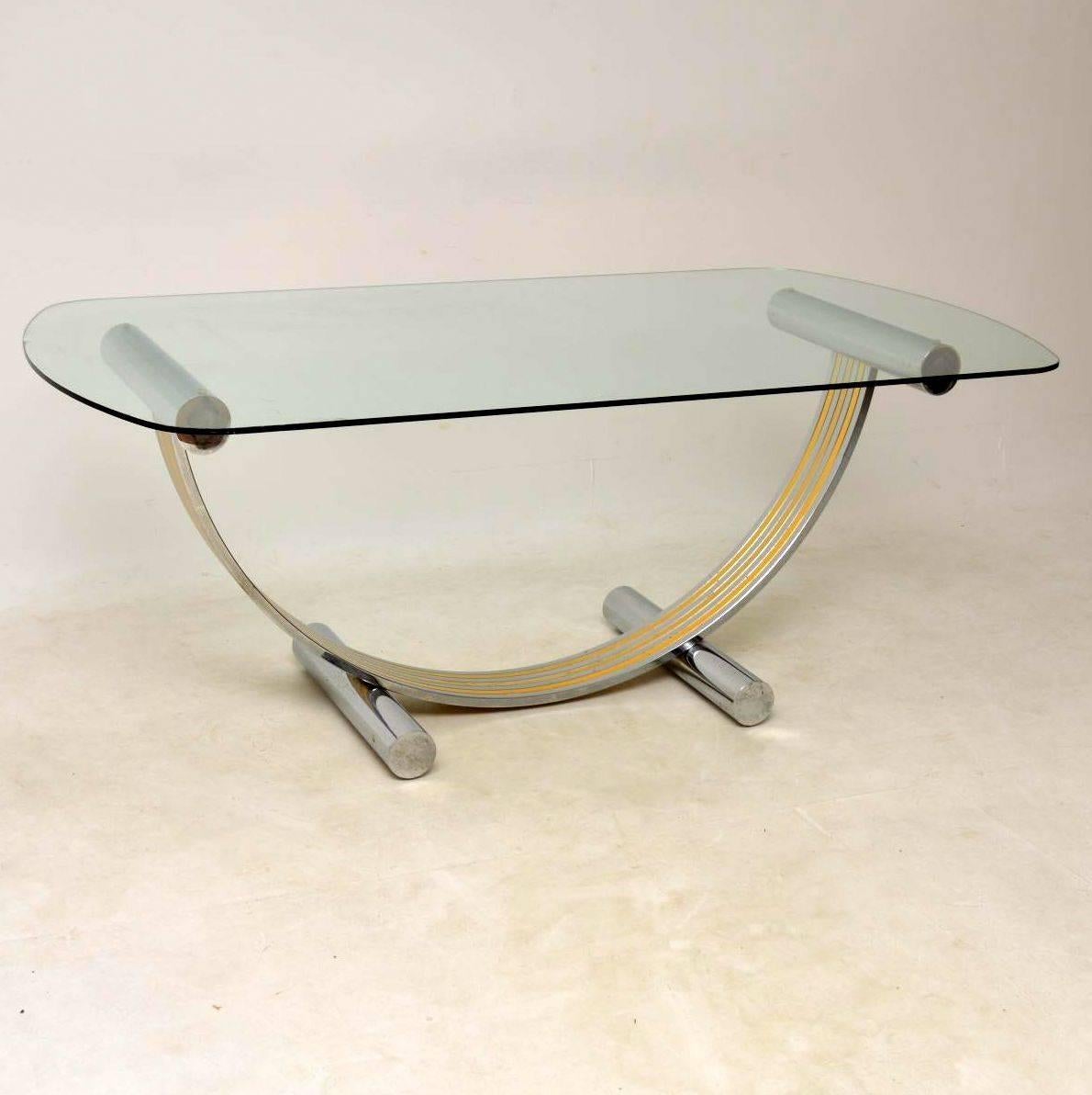 A stunning vintage dining table and chairs, these were made in Italy and were designed by Renato Zevi. The table has a large toughened glass top that's in excellent condition, there is just some extremely minor wear to one edge. The base is chromed