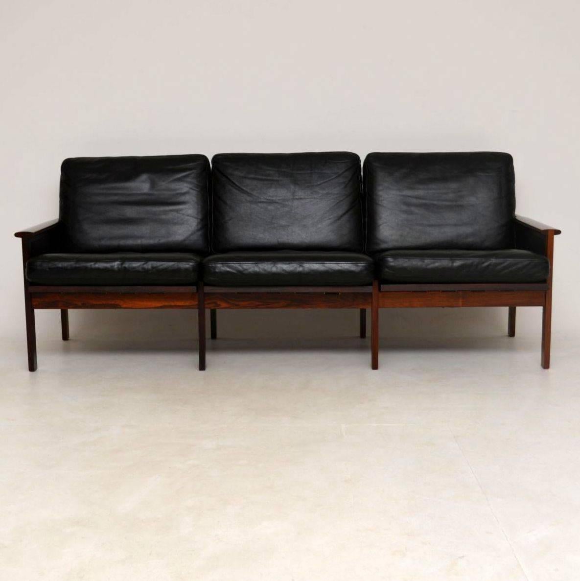A stunning vintage three seat black leather sofa, this was designed by Illum Wikkelso in 1958 and was made by Niels Eilersen. We have had this fully restored so the condition is superb throughout, the frame has been stripped and re-polished; there
