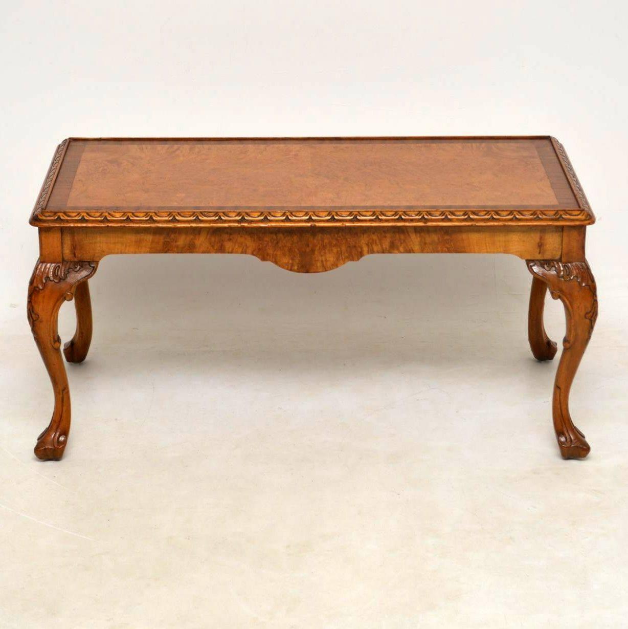 Antique walnut coffee table in excellent condition dating from around the 1920s period. It’s very good quality and has some nice details. The top looks like burr maple, with a cross banded edge of walnut. It’s carved around the top edge and has