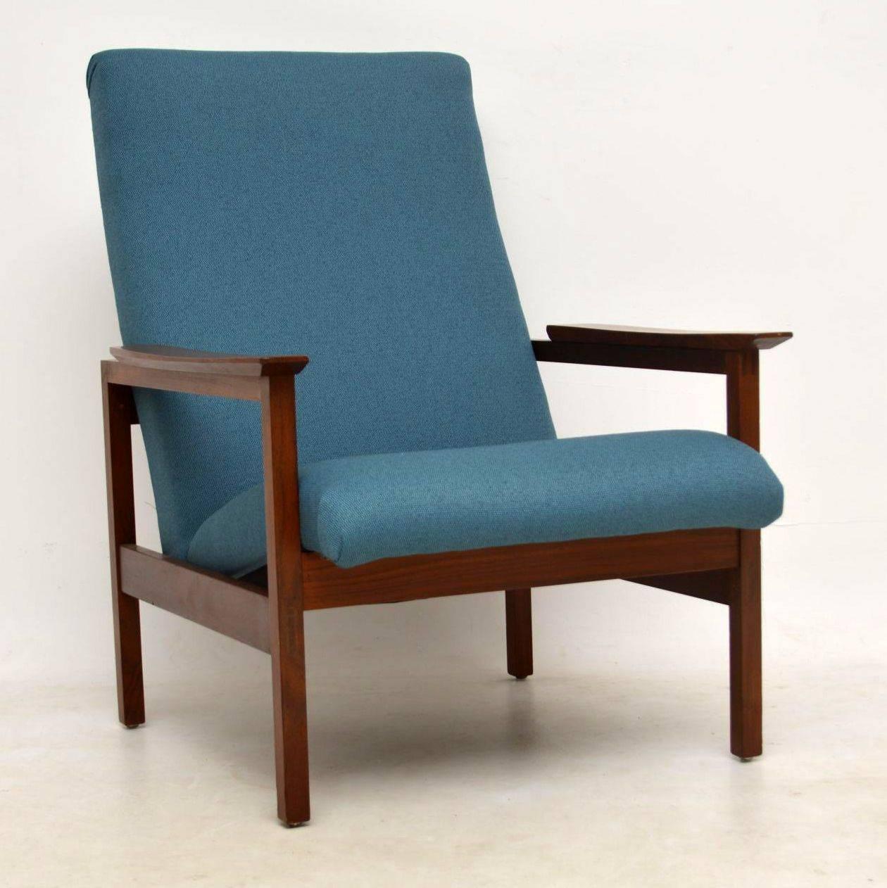 A top quality and extremely comfortable vintage armchair, this was made by Guy Rogers, it dates from the 1950s-1960s. The frame is solid Afromosia wood, it is nicely polished, clean and sturdy. We have had this fully re-upholstered in a beautiful