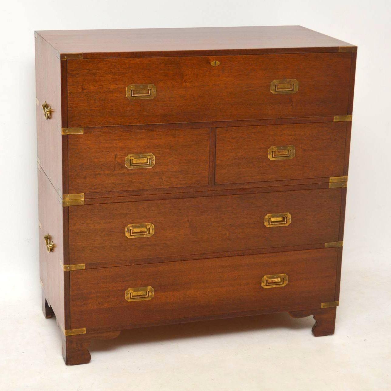 Antique Campaign style mahogany secretaire chest of drawers in good condition. It comes apart into two sections for easy transportation and has brass carrying handles on the sides. It also has brass corner fittings and inset brass military handles
