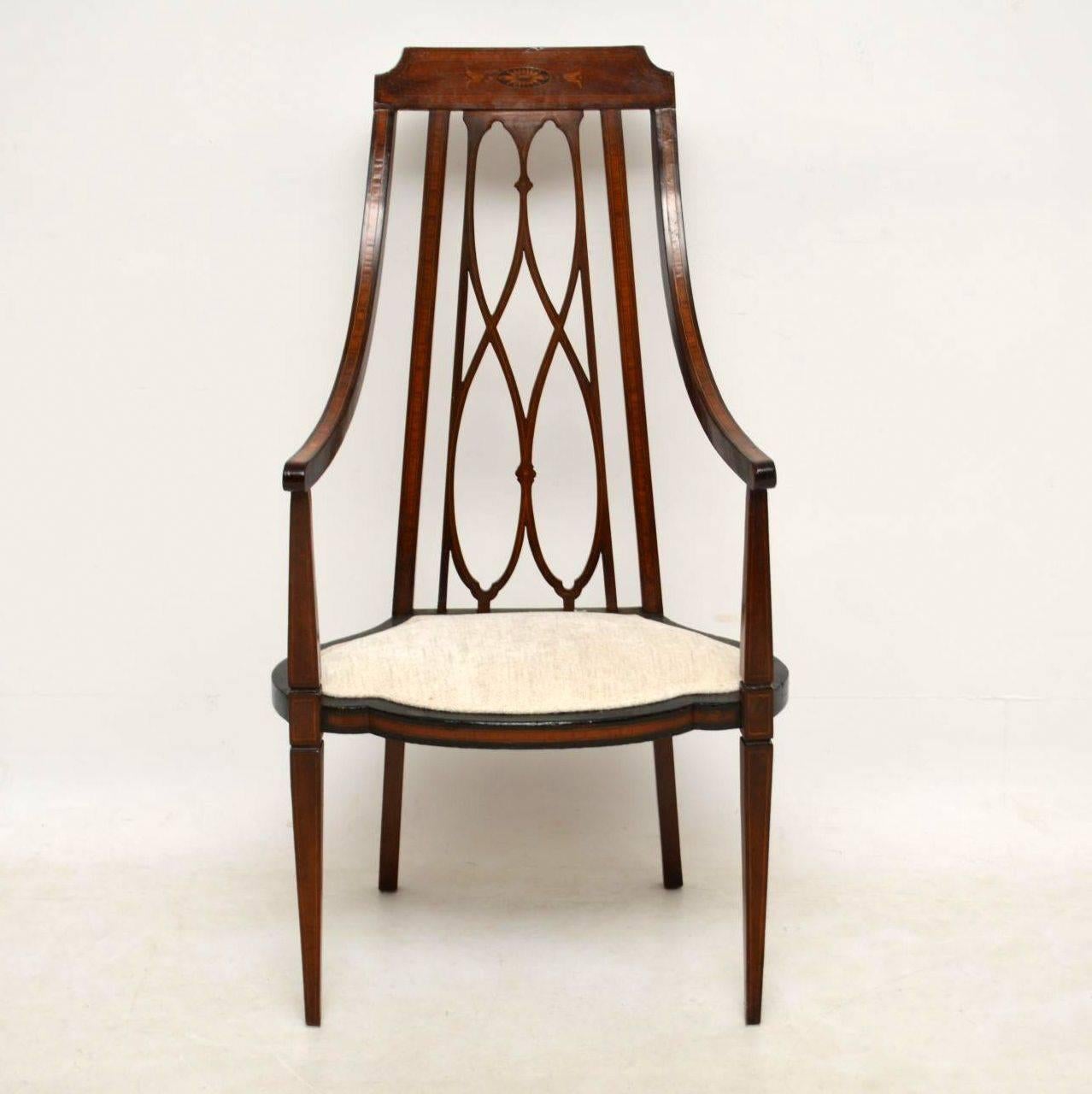 Very elegant, stylish antique Edwardian armchair with a newly upholstered seat. It's solid mahogany, with various intricate inlays of satin wood, tulip wood & ebony. This chair is in good condition & dates from the 1890-1910 period. It has a high