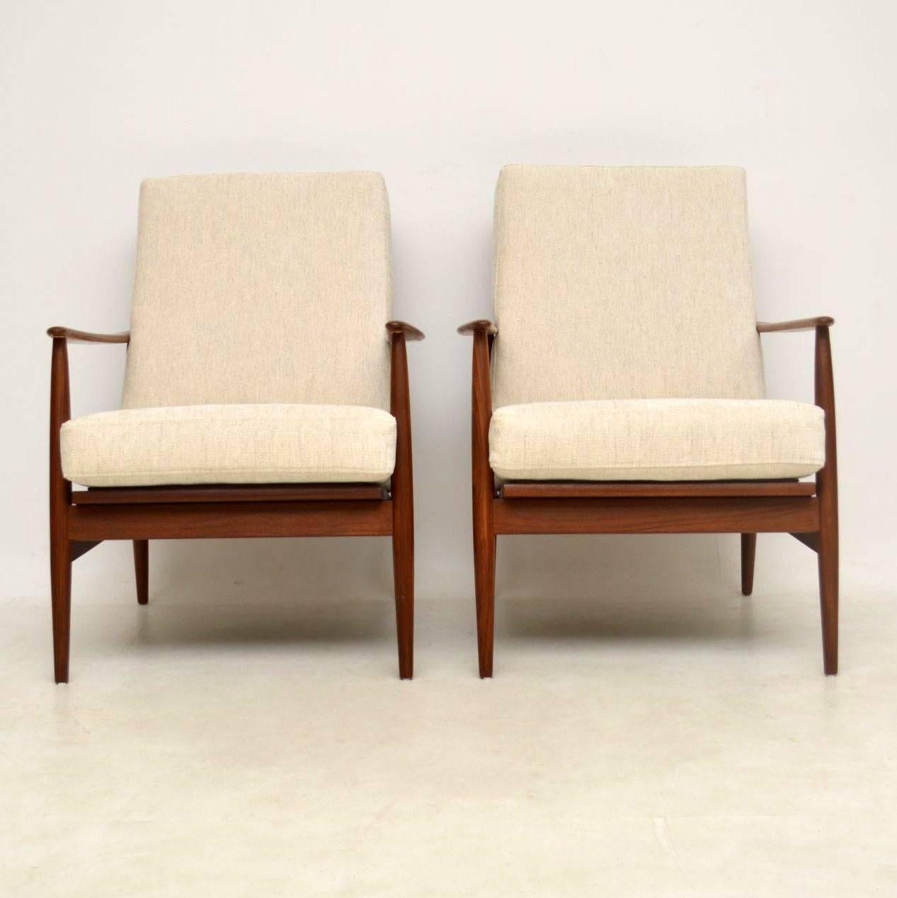 A beautiful pair of vintage armchairs in solid Walnut, these date from the 1960s. They are in the classic Scandinavian style, and they’re of great quality. The condition is superb for their age, the frames are nicely polished with lovely grain