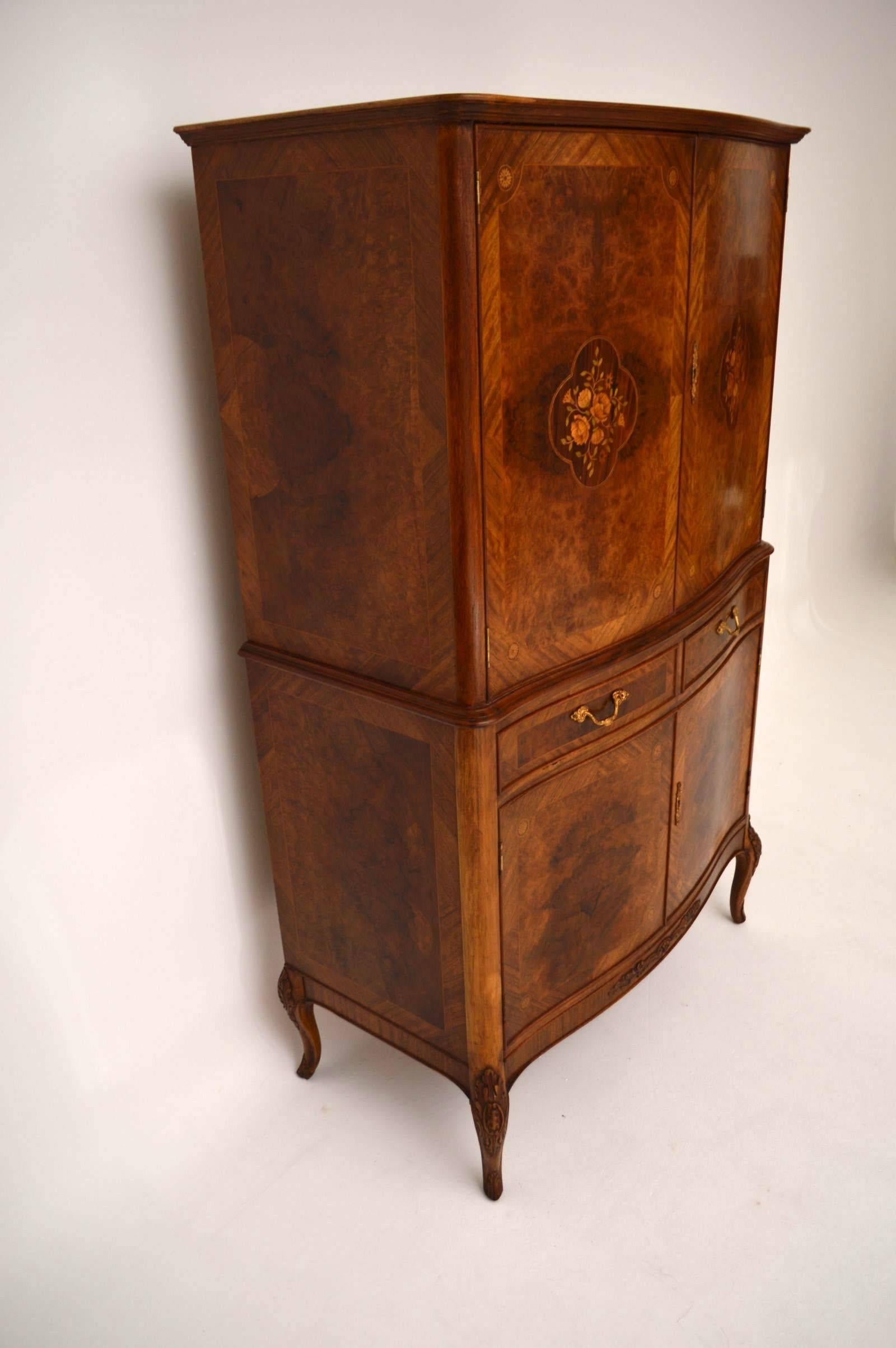 Antique French style cocktail drinks cabinet with stunning burr walnut door panels and intricate floral marquetry on the top doors. The sides are also burr walnut and there are other woods on this piece, like rosewood and many exotic woods in the