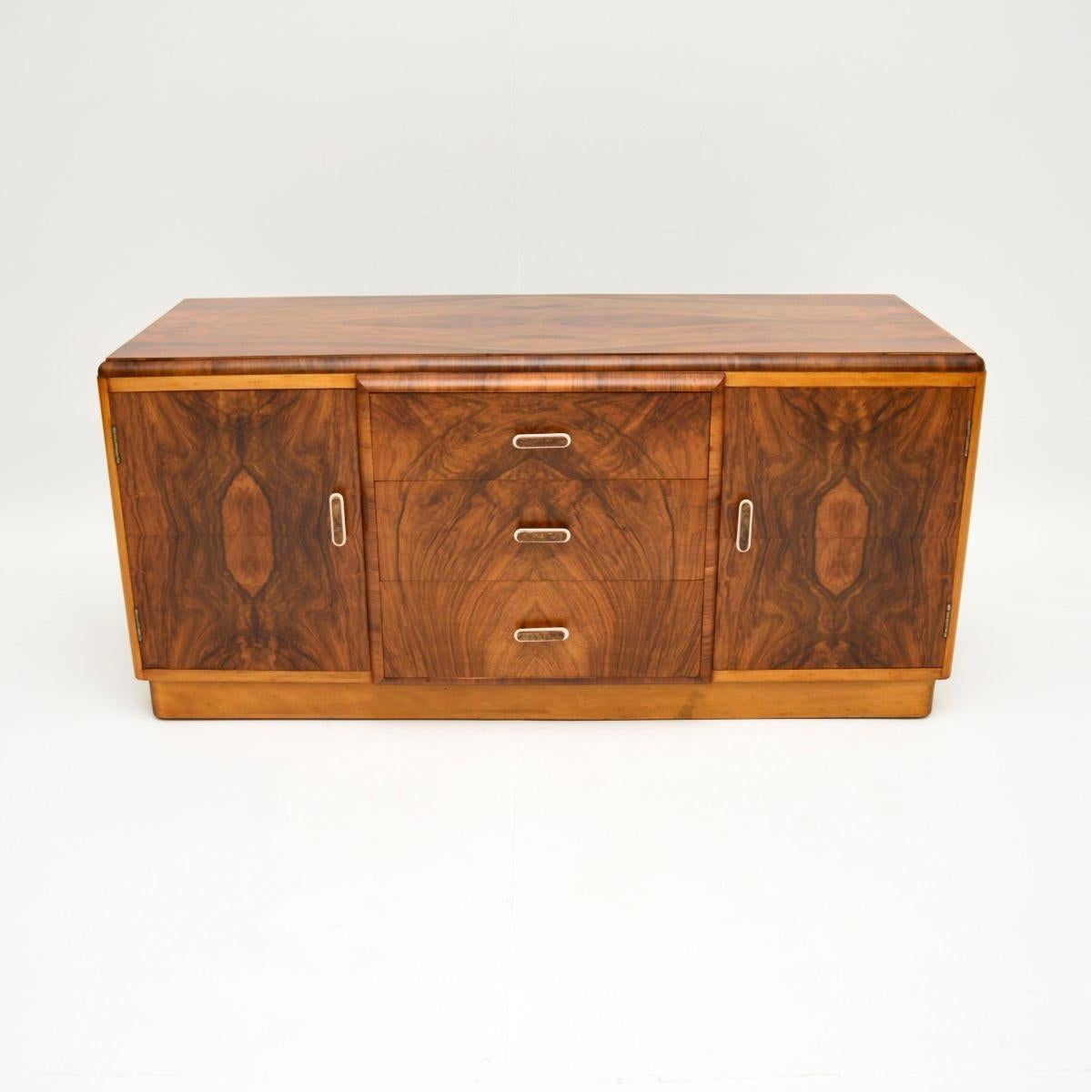 A stunning Art Deco figured walnut sideboard. This was made in England, it dates from the 1930’s.

The quality is outstanding, this is a very useful size, being quite low and compact. The walnut grain patterns are stunning, this has beautifully