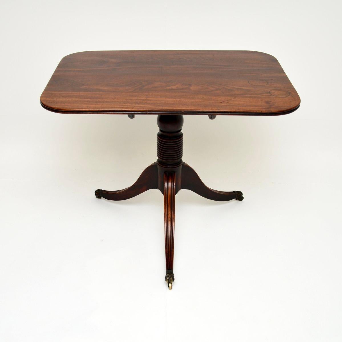 A smart and very well made antique Regency Period tilt top table. This was made in England, it dates from around the 1800-1820 period.

It is of excellent quality, it is thick and beautifully constructed. The rectangular top can tilt upwards to save