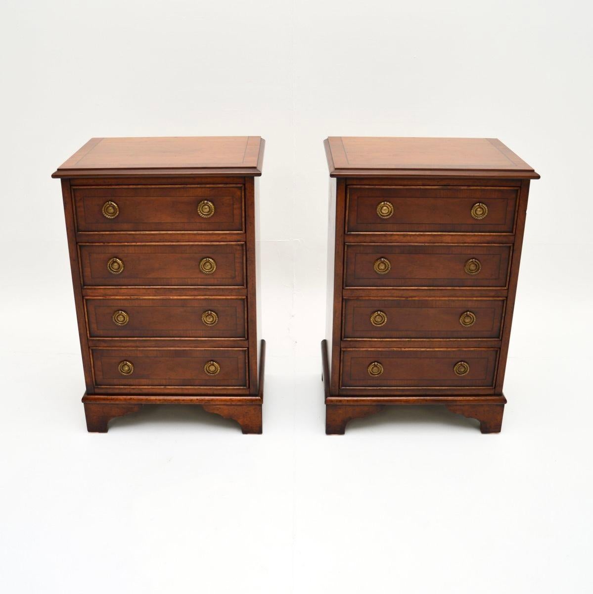 A lovely pair of antique Georgian style yew wood bedside chests. They were made in England, they date from around the 1950’s.

They are of superb quality and are a very useful size. Each has four drawers with lovely brass ring pull handles, they sit