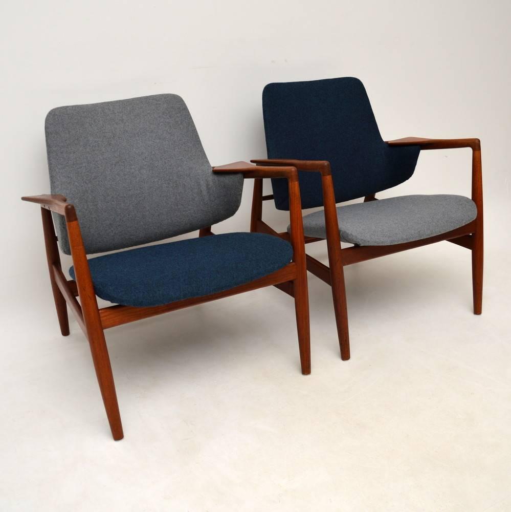 A stunning pair of Danish teak armchairs, recently upholstered in wool fabric. We're not sure of the designer, but the design is pretty spectacular! We think they are probably a rare design by Kofod Larsen or maybe Arne Vodder or Finn Juhl. Whoever