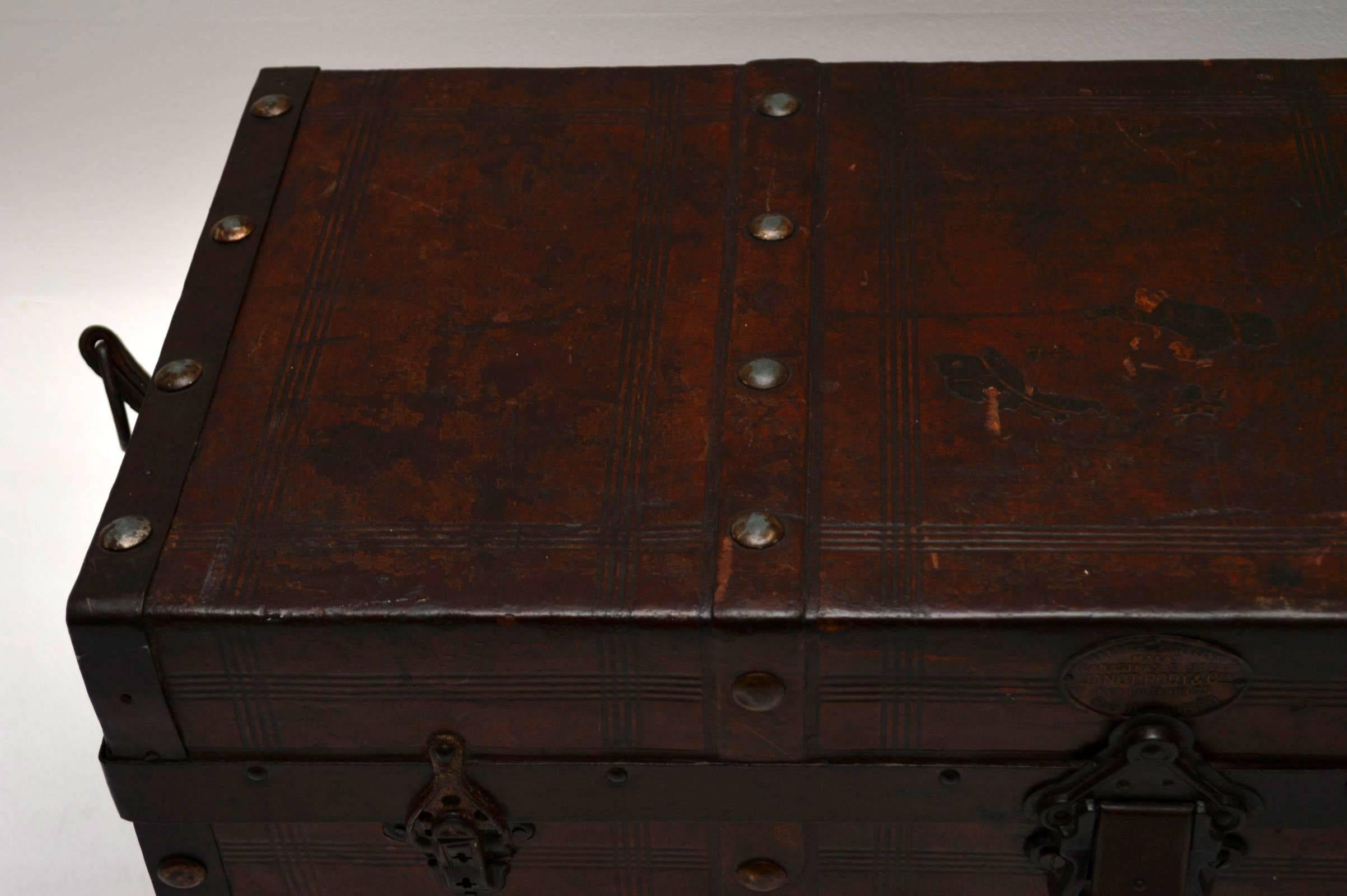 Very decorative antique leather bound travelling trunk that looks like it was made in Rio De Janeiro Brazil. It must be 19th century and it's in pretty good condition considering it's age and use. This trunk has a nice metal label on the outside and