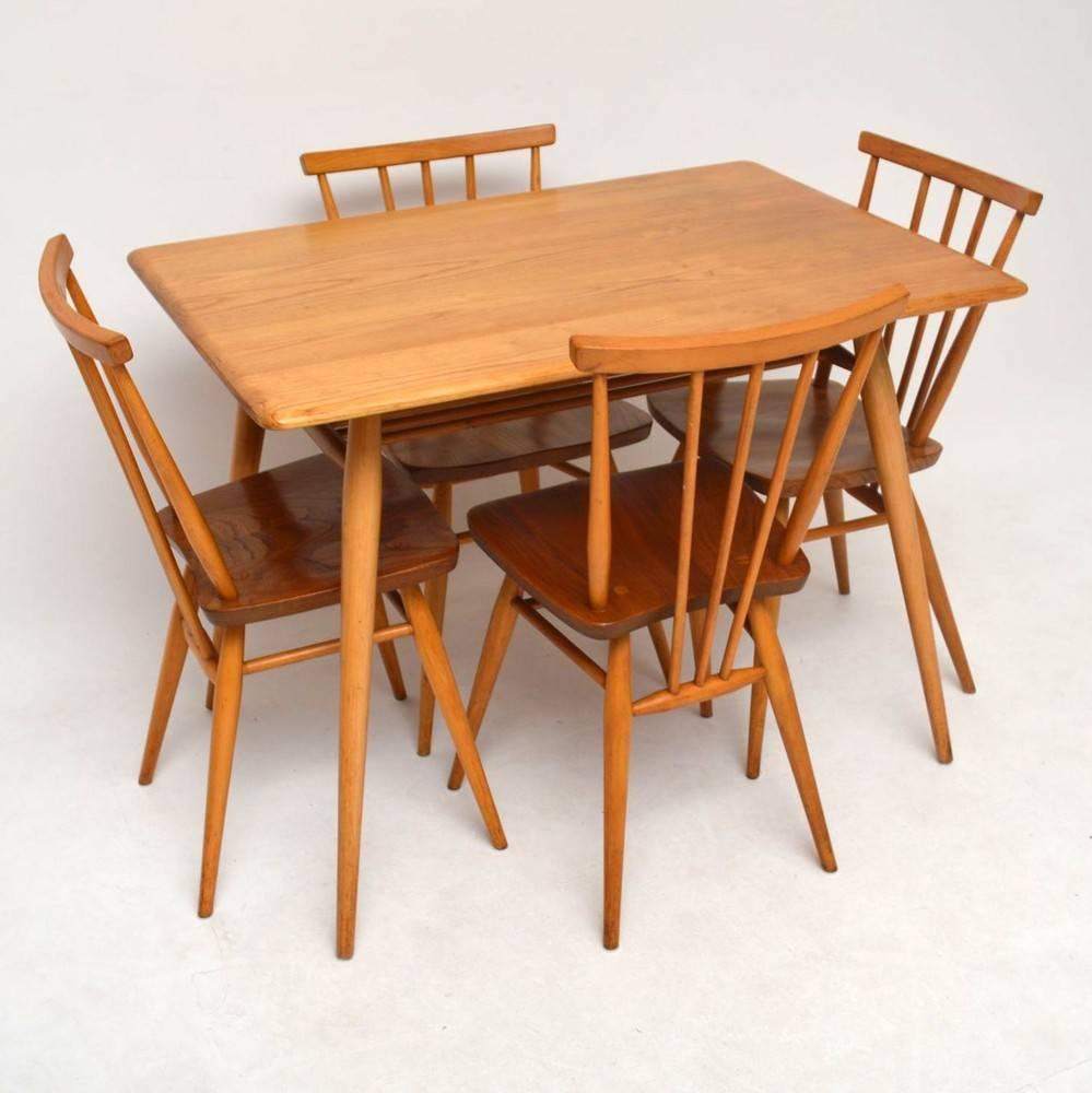 A beautiful and compact dining set by Ercol, this dates from around the 1960s-1970s. It's made from solid elm, the condition is excellent throughout for its age. The table is sturdy and clean, with beautiful grain patterns and only some extremely