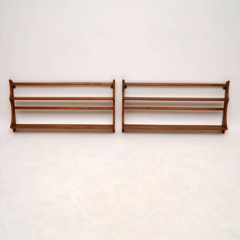 A beautifully made pair of solid elm hanging plate racks or bookcases, these were made by Ercol and they date from the 1960s. The condition is superb for their age, with hardly any wear to be seen. In addition to these we also have the matching