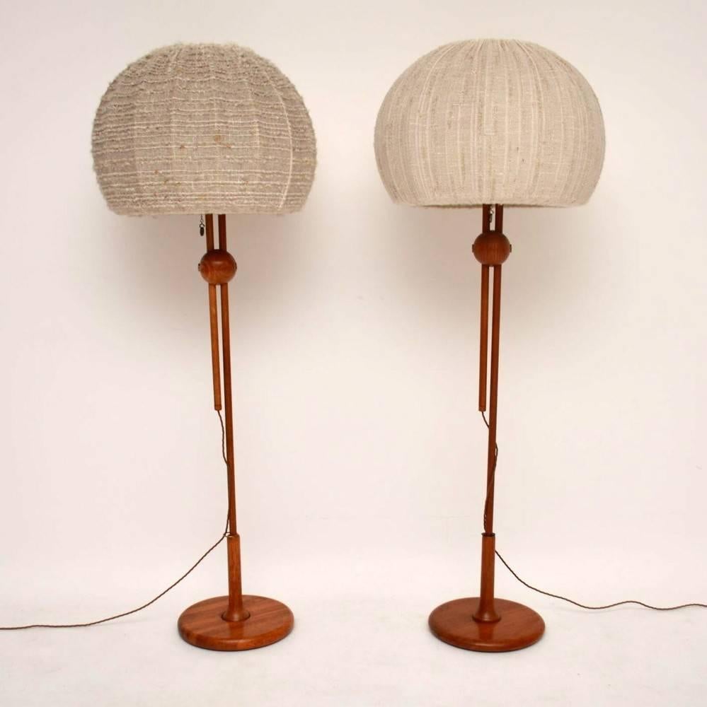 A stunning pair of solid teak rise and fall lamps, these were made in Germany by Temde, they date from the 1960s. They are in excellent condition for their age, the Teak is nicely polished and the rise and fall mechanism works well. These have just