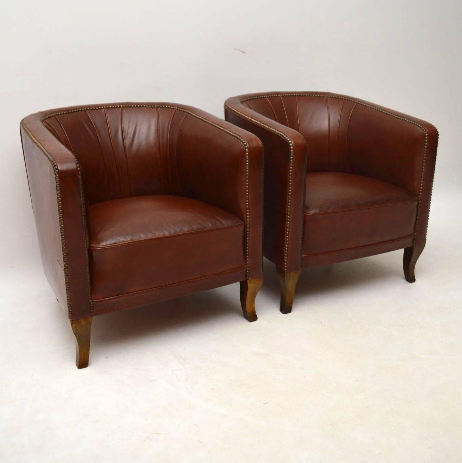 Very comfortable and stylish pair of antique Swedish leather armchairs on satin birch legs. They have tub backs that are stylishly piped inside and there are two rows of hand tacking around the edges. The seats are well sprung and there is plenty of