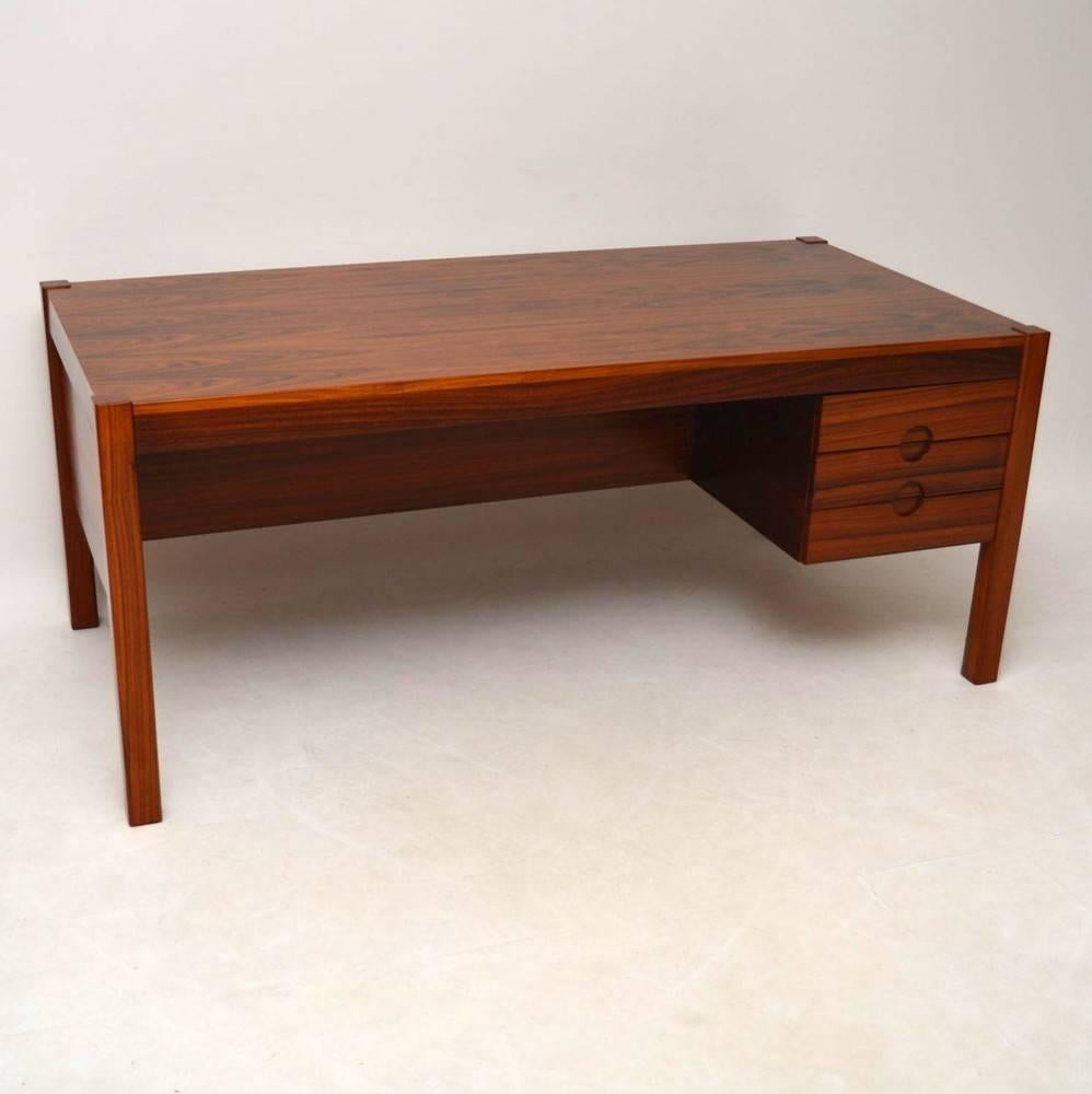 A beautiful and impressive desk in rosewood, this was made in Denmark and it dates from around the 1960s. We have had this stripped and re-polished to a very high standard, the condition is superb throughout. The back is also beautifully finished,