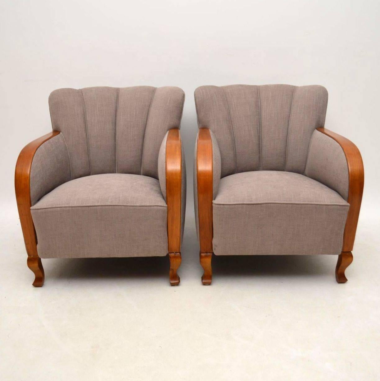 Very comfortable pair of original Swedish Art Deco armchairs. They have just come over from Sweden, been re-polished and re-upholstered in a neutral coloured fabric. The curved backs are ribbed and the seat is fully sprung. They have curved arms