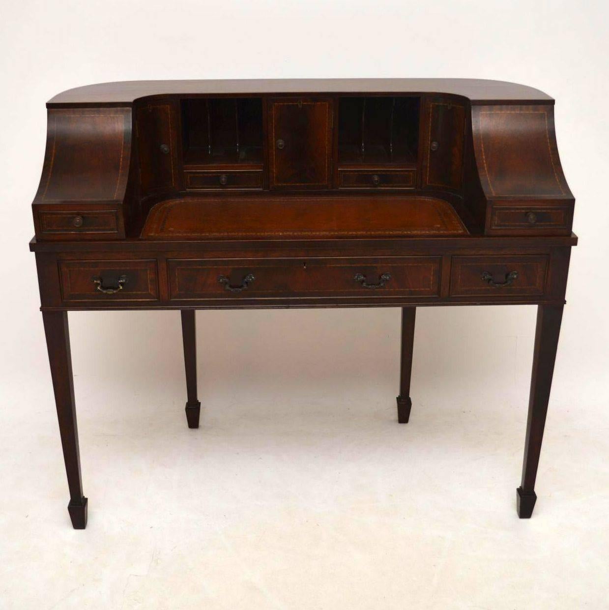 This antique Sheraton style 'Carlton House' desk is good quality & is a 20th century copy of this famous design. I would date it from around the 1950s-1960s period and to look at, it has the look of an Edwardian piece. This desk is predominately