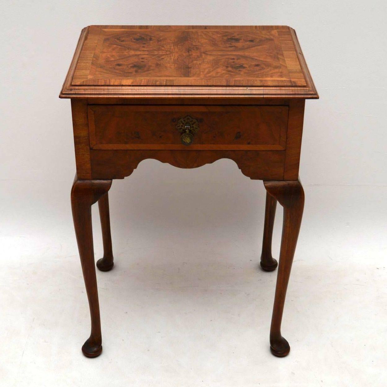 Small antique walnut side table with one drawer, a polished back and sitting on solid walnut legs. The top is a densely patterned burr walnut, with herringbone inlay and figured walnut crossbanding, plus a moulded walnut edge. The drawer is also