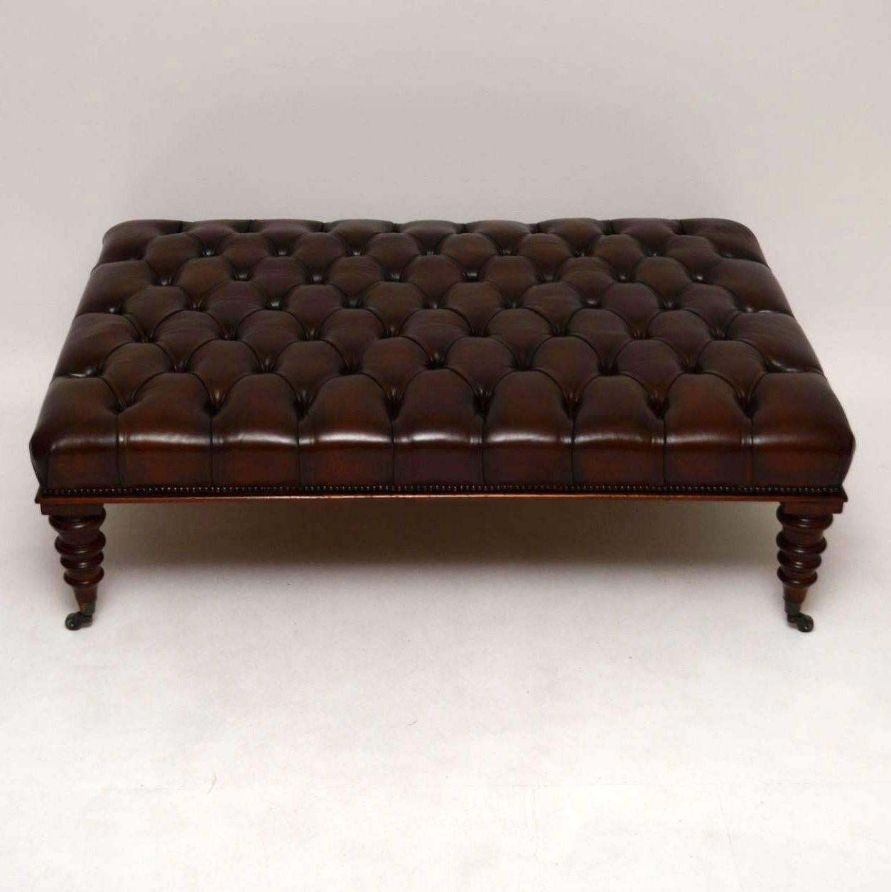 This large antique deep buttoned leather and mahogany coffee table stool is in stock right now. I have just had two more made, because they seem to be very popular. As usual, we can have them made to order any size or color. They are very high