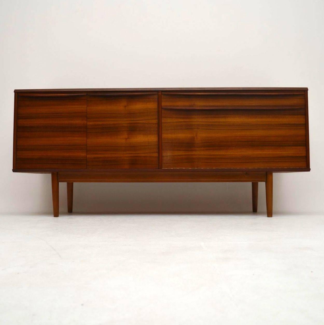 A beautifully designed and top quality sideboard in walnut, this dates from the 1960s, it was made by Morris of Glasgow. The condition is superb throughout, with hardly any wear to be seen. It has a lovely color and gorgeous grain patterns; its a