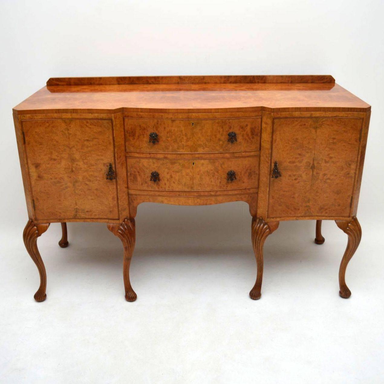 This antique walnut and burr maple sideboard was made by the famous London cabinet makers Epstein, hence the quality. It has a lovely mellow color and is in excellent original condition. The patterns on the veneers are beautiful. There are two