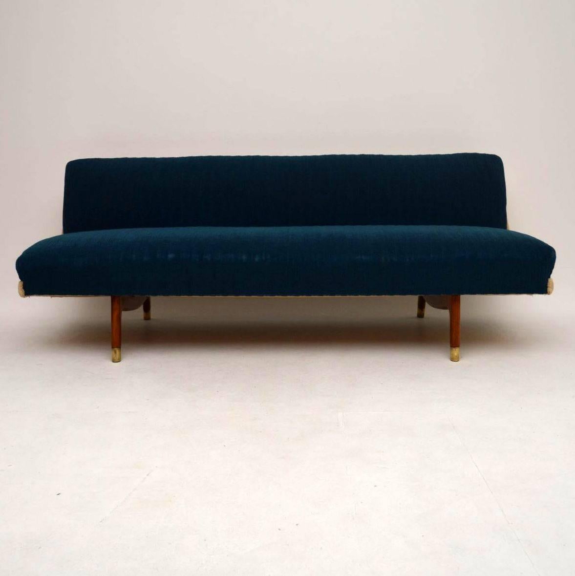 A very stylish and comfortable vintage sofa bed, this was made in Denmark, it dates from around the 1950s-1960s. It is in very good condition for its age, with some minor wear here and there. The blue fabric is free from any marks, it has worn a