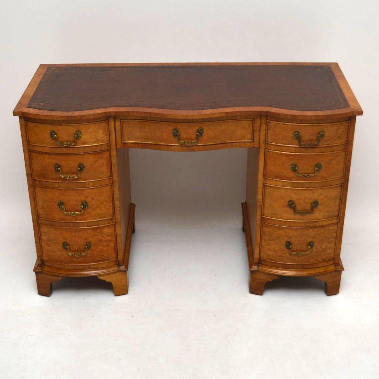 This antique burr walnut desk has a great shape and a wonderful mellow color. The burr walnut has intricate patterns all-over the front, sides and back. The tooled leather writing surface is original and still in good condition. The desk front is
