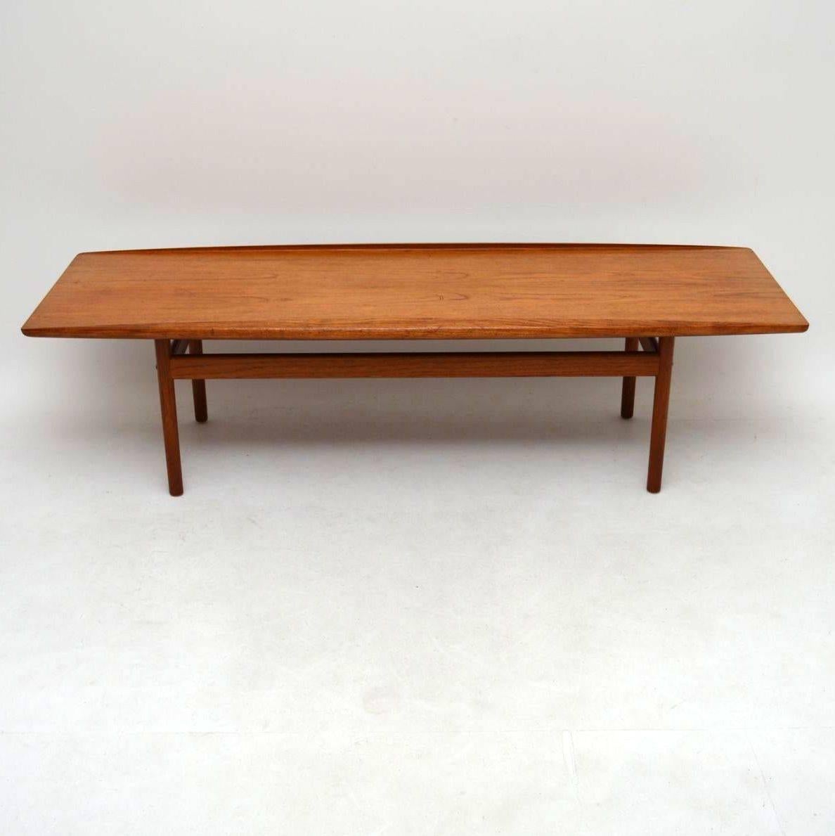 A very impressive and well made Danish Teak vintage coffee table, this was designed by Grete Jalk and was made in the 1960s by Poul Jeppesen. The condition is very good for its age, with some minor wear to the polish on the top, and one or two old