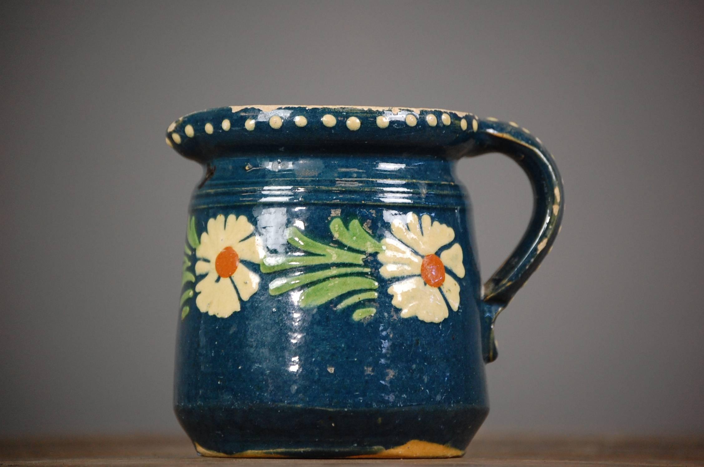 Charming late 19th century French slipware cream jug, originating from Burgundy, blue base and floral design.