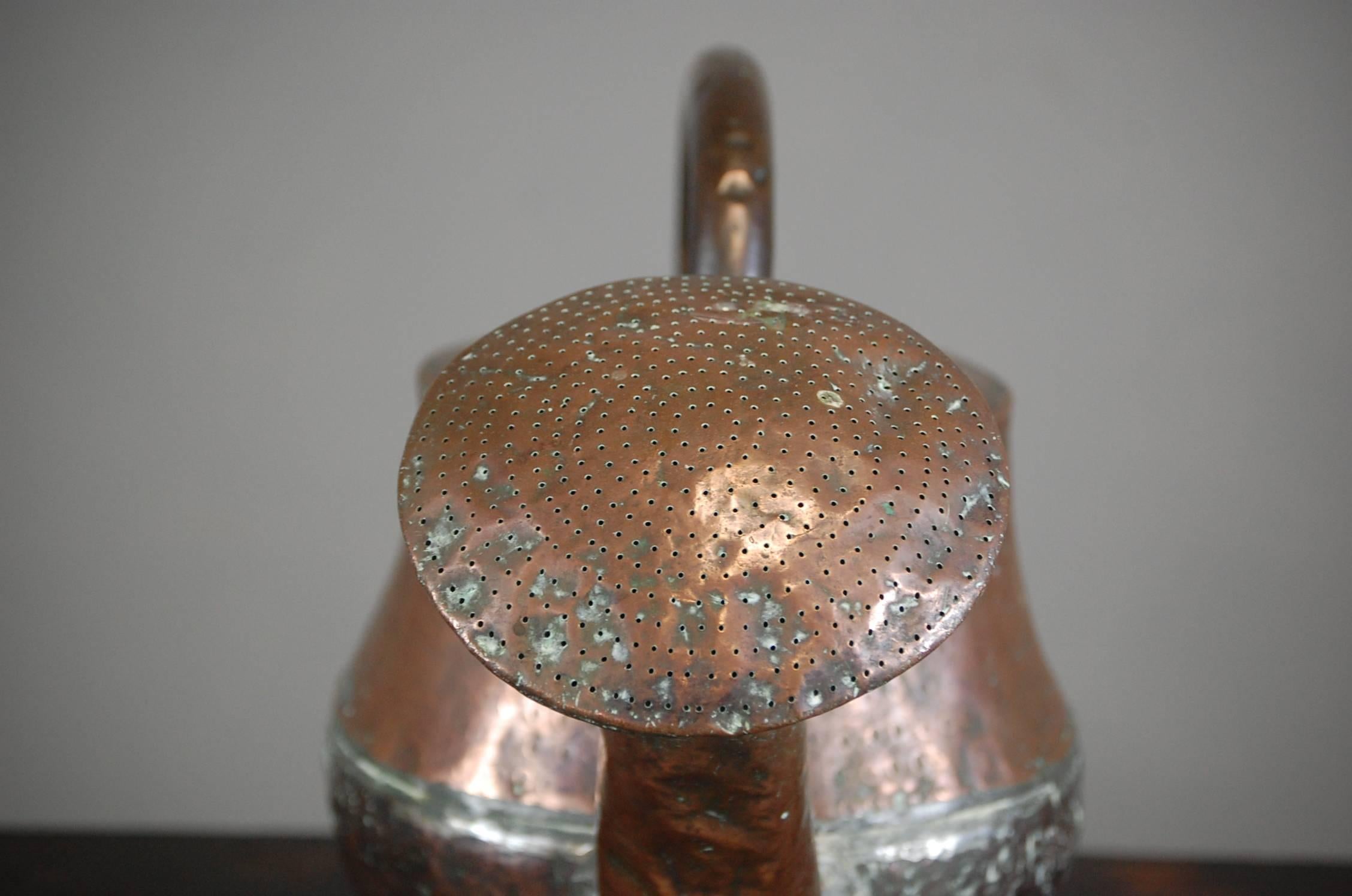 French copper watering can. Large in scale and highly decorative with its wonderfully oversized rose. Several old repairs. Wear consistent with age and use. French. circa 1850.