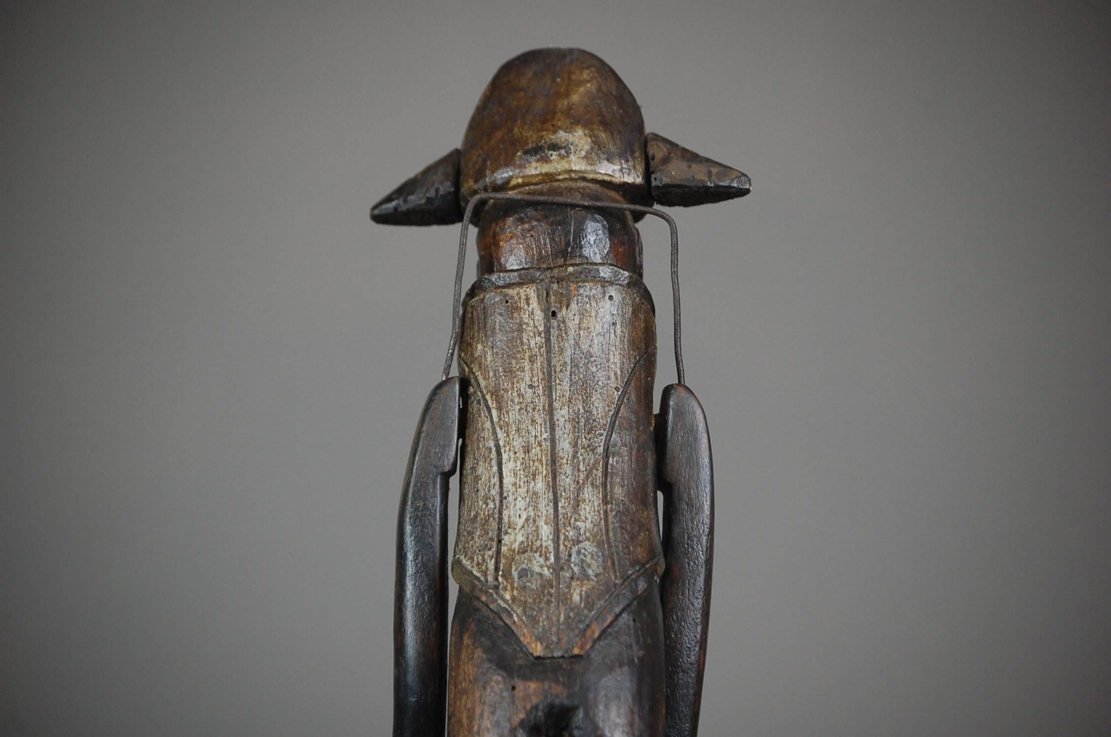 Naive carved wooden toy doll depicting a French soldier. More than likely made by a father to give to his son. The lever to the rear when pulled lifts the dolls arms up and down accordingly in a 