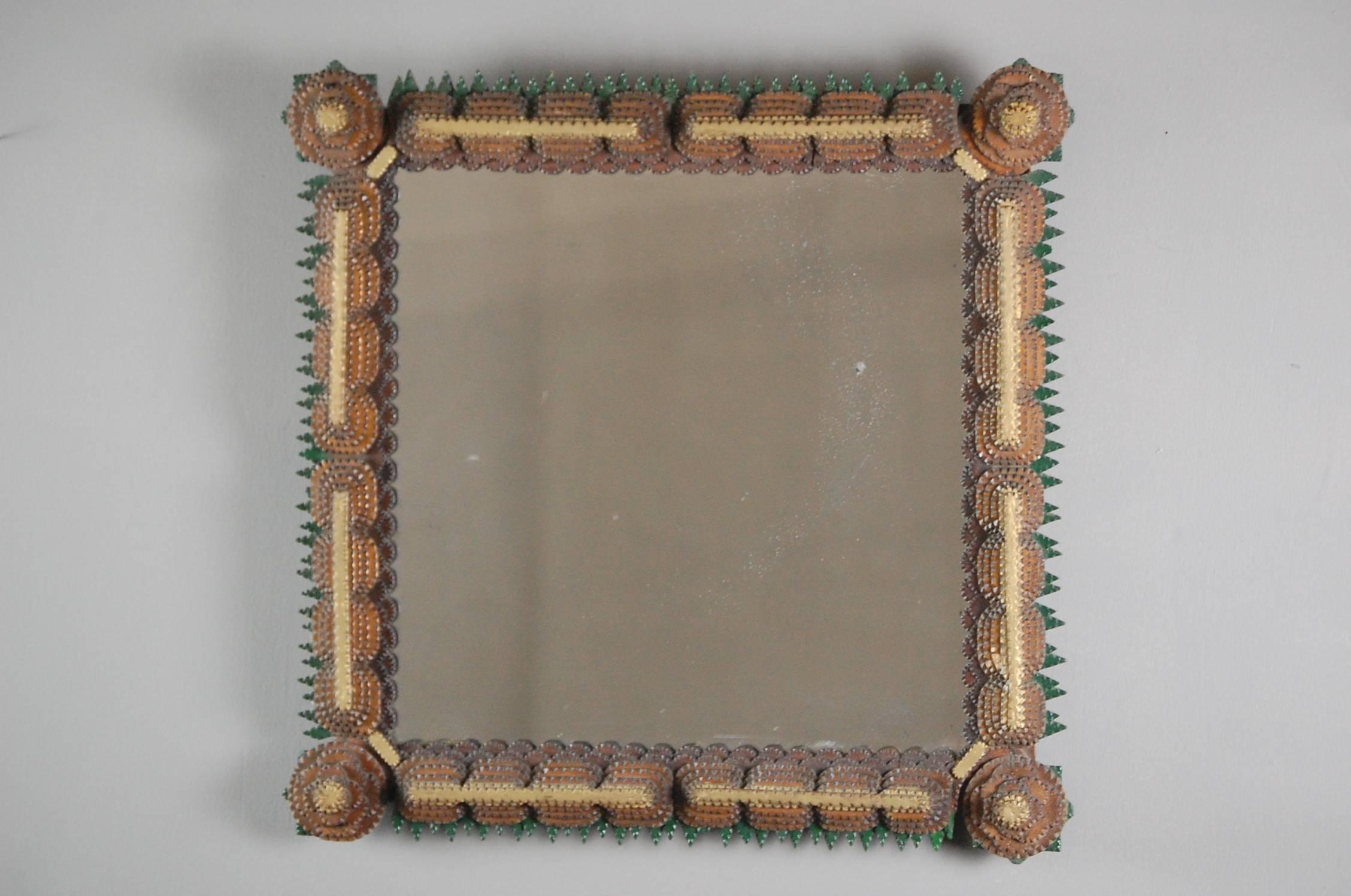 Early 20th century intricate Tramp Art mirror, remarkably detailed, and unusually painted. The mirror plate is more than likely earlier, as it is mercury backed with a wonderful sparkle and lightly foxed. Minor losses, French, circa 1900.
 