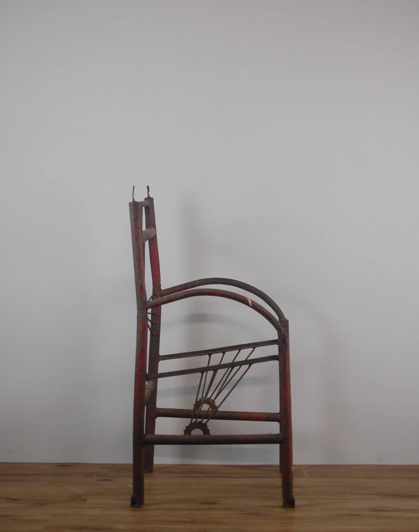 Wonderfully primitive chair constructed from bicycle parts, Lincolnshire England, circa 1915. Used later as advertising display piece in a bicycle store. Remnant original paint, lightly waxed. Decorative display piece.