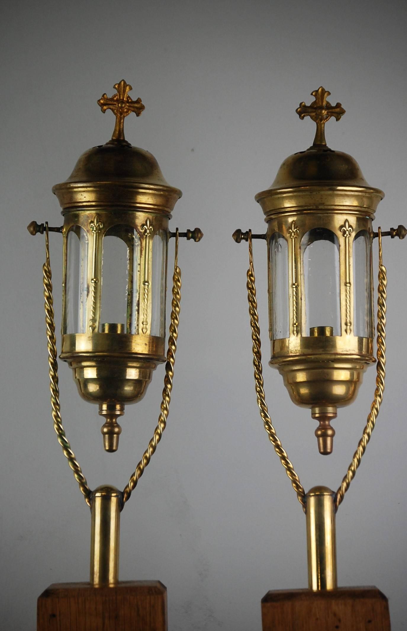 A wonderful small pair of French Church processional lanterns, original circular glass. Lightly tarnished as unpolished, early 20th century. Mounted (removable) on later bespoke oak stands. Measurements inclusive of stand.