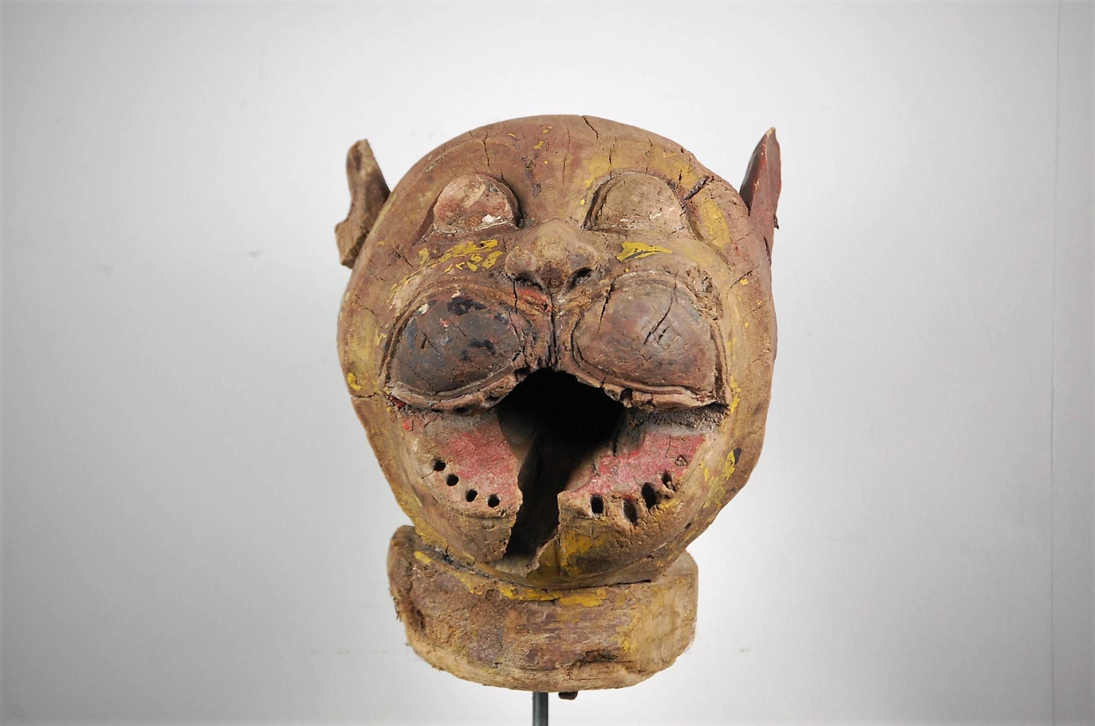 Late 19th century French fairground or carnival leopard head, carved wood, heavily distressed, remnant paint work, France, 1875. Later steel stand.