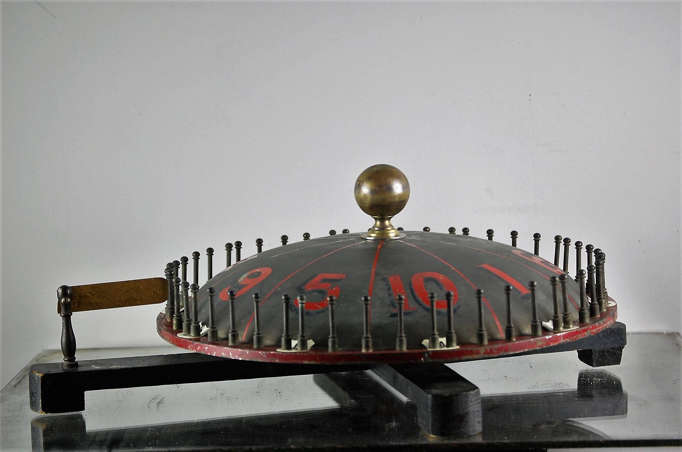 Late 19th century roulette or game of chance spinning wheel, unusual convex shape, hand-painted numerals, great patination, still spin enthusiastically!