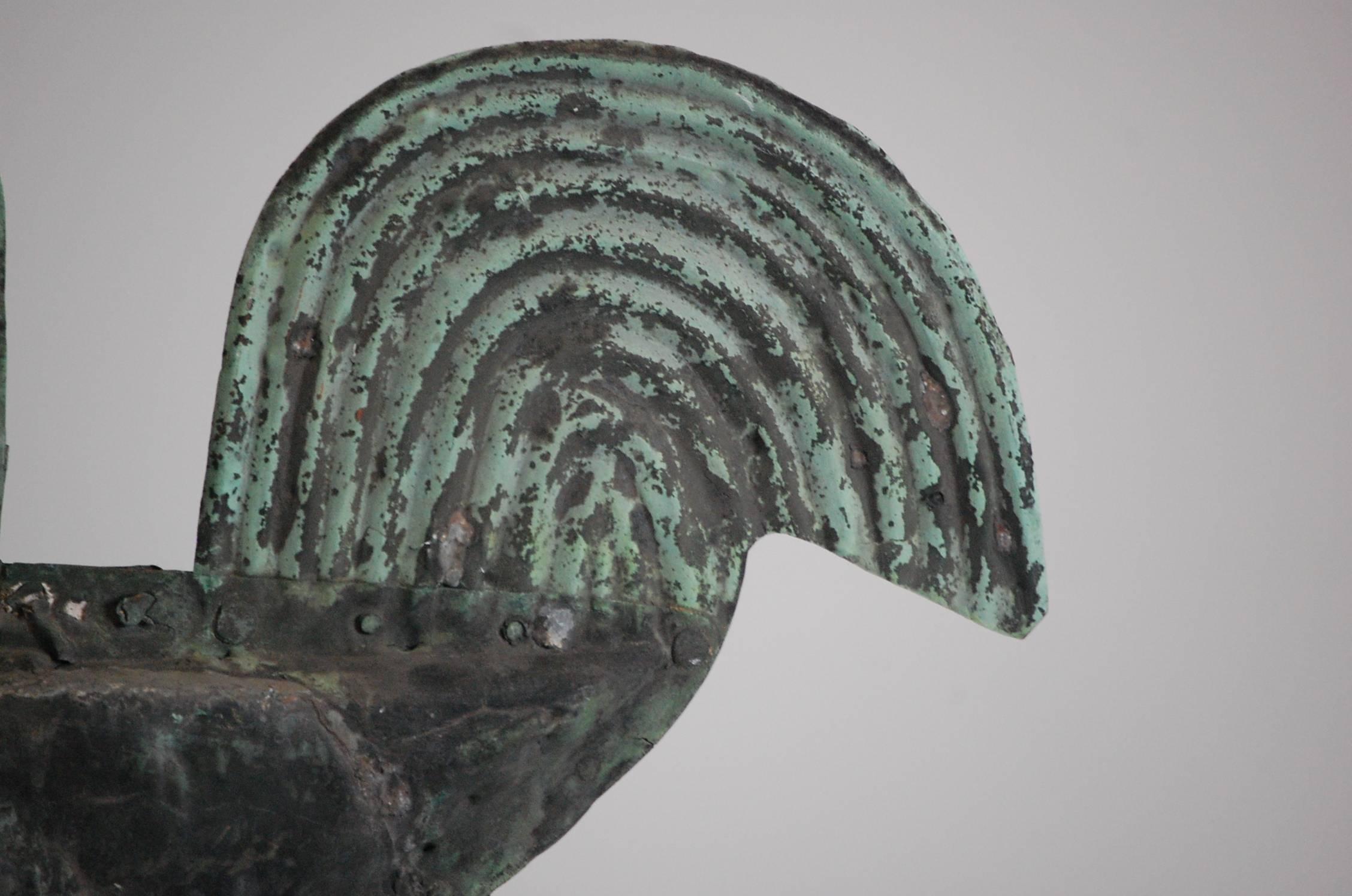 Early 19th century stylised full bodied cockerel weathervane, bulbous body and charmingly oversized head, stylised tail and comb. Wonderful patinated surface, with natural verdigris, evidence of period working repairs. Great example of authentic