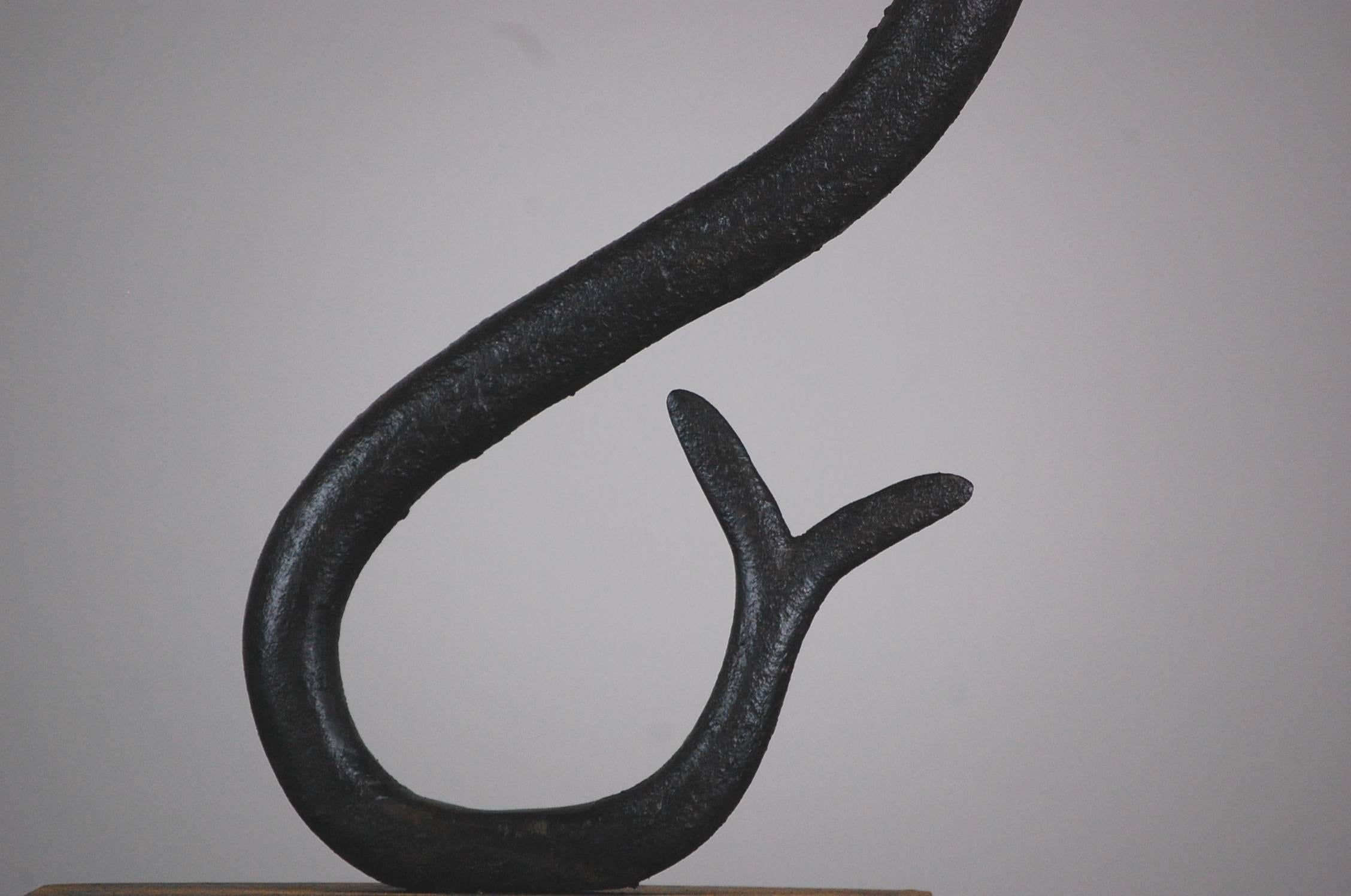 Early 19th century apothecary snake trade sign, although full bodied solid wrought iron, this example creates a wonderful bold Silhouette as required by such early signs. Original wrought iron hanging loop. Wonderful pitted textured surface showing