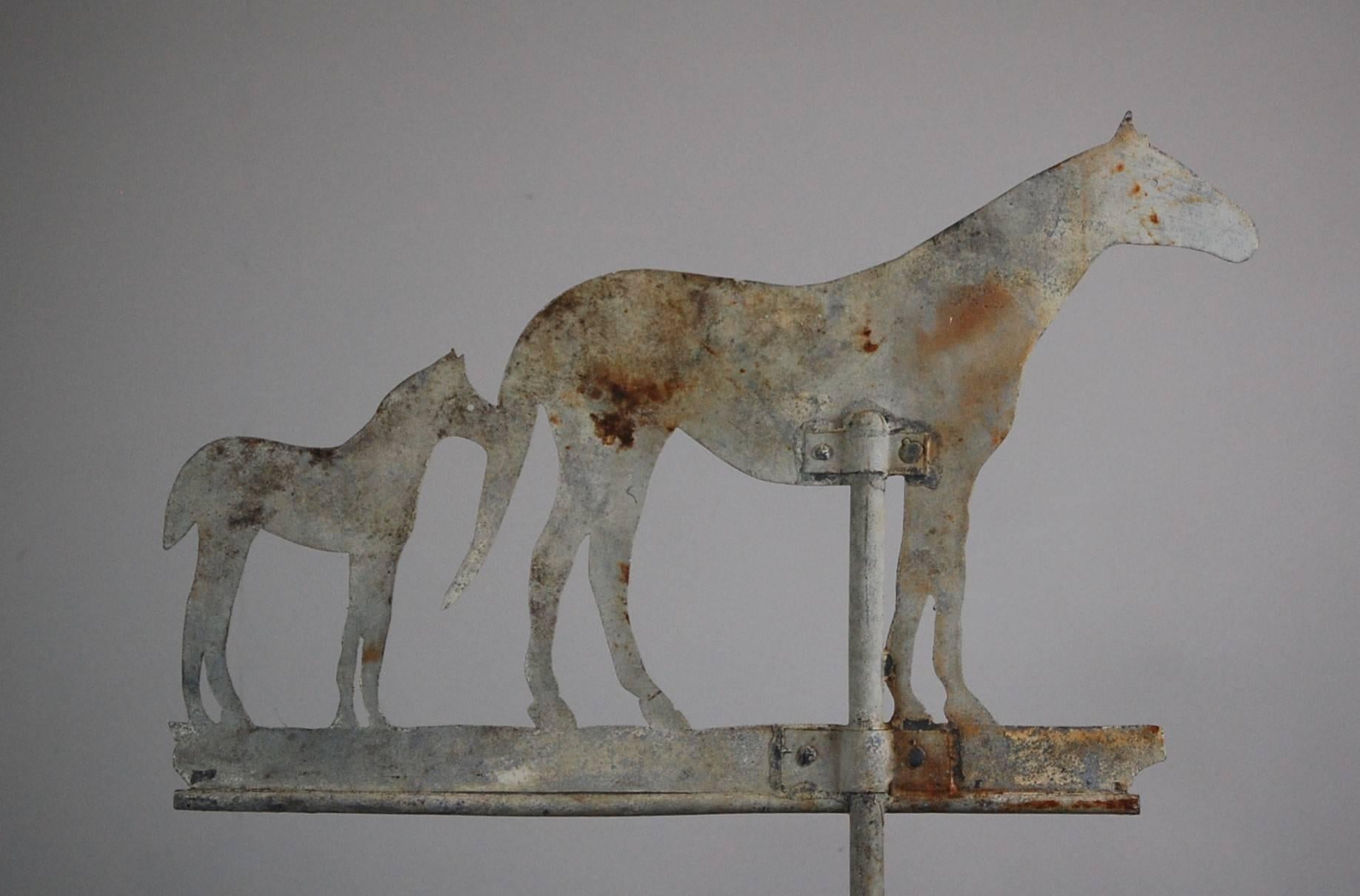 Early 20th century zinc livery yard Silhouette weathervane, depicting horse with foal. Original dry paint finish. Later contemporary steel stand.