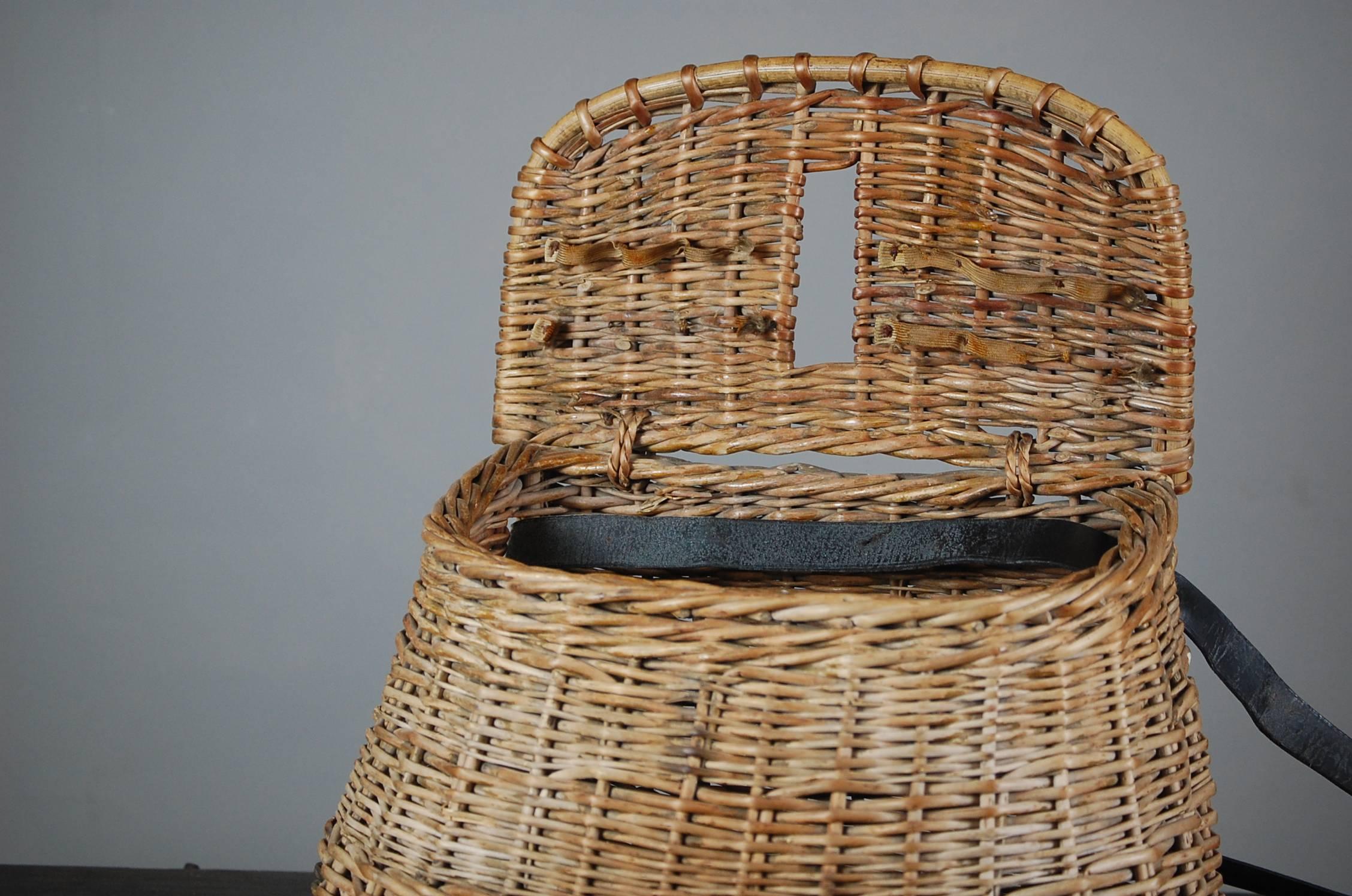 Early 20th century English wicker fishing creel, remarkable condition this does indeed show signs of use but is fully functional with leather over shoulder strap. English, circa 1925.