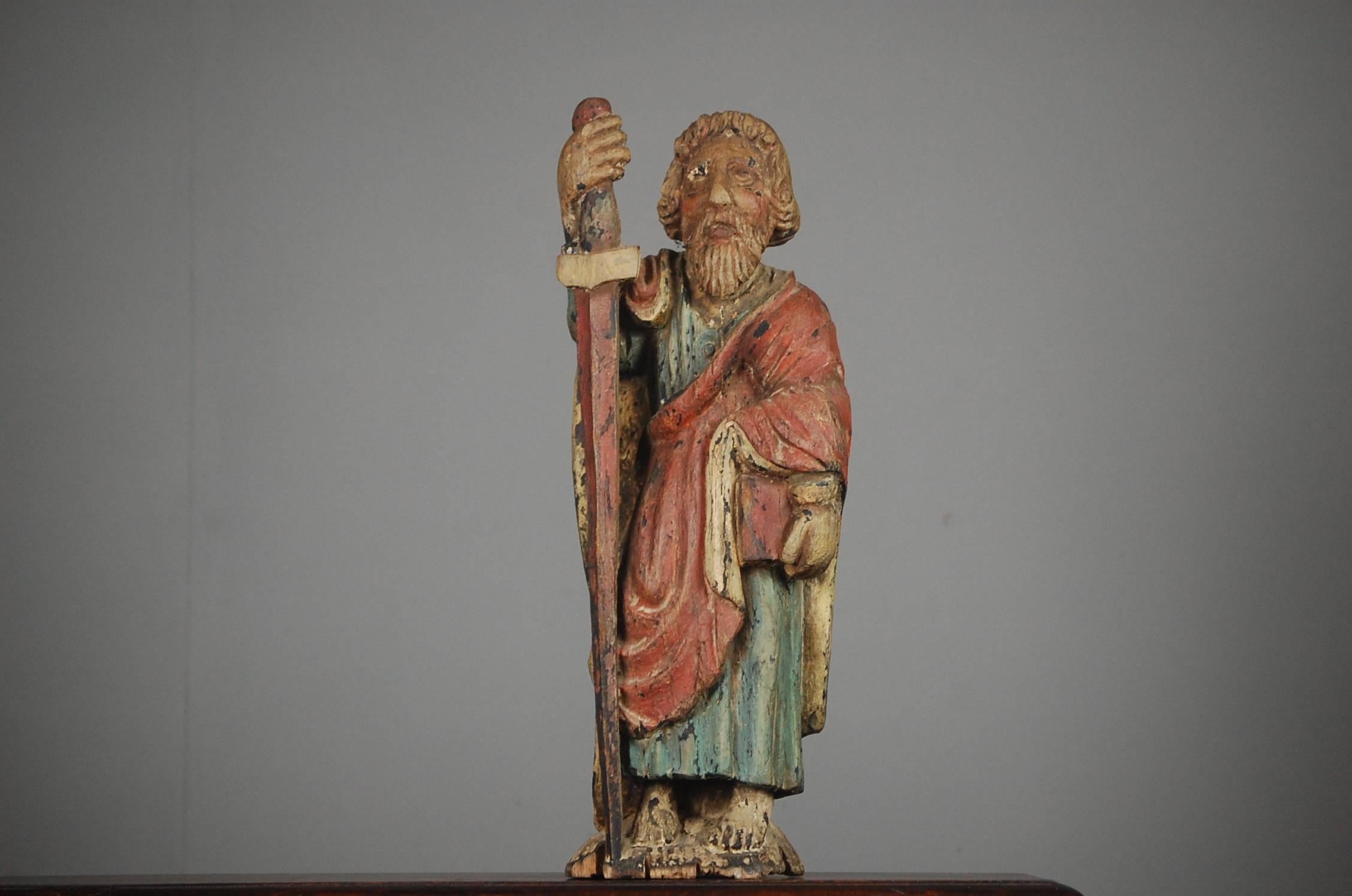 Naïve carved wood, original distressed paint finish depicting Saint Paul, the book carried represents his gospel in the New Testament. The sword a reminder of the means of his martyrdom. Minor Losses. France, circa 1860.