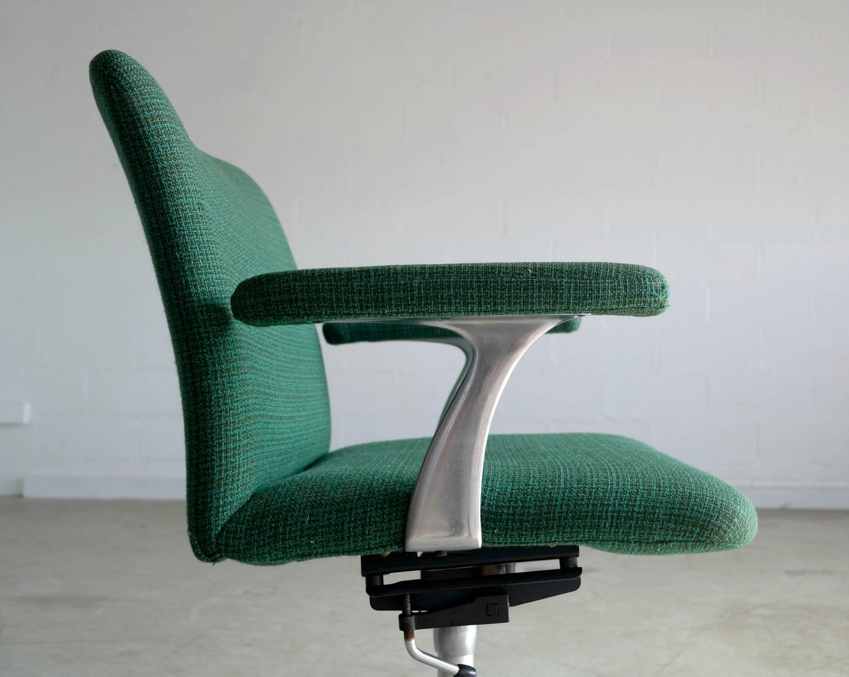 Swivel base office chair model 208 by Cado Systems (Poul Cadovius) with a lockable tilting mechanism. Chair is often attributed to Finn Juhl. Polyester fabric showing appropriate age wear and chair in overall very good condition. 1960s at its best.