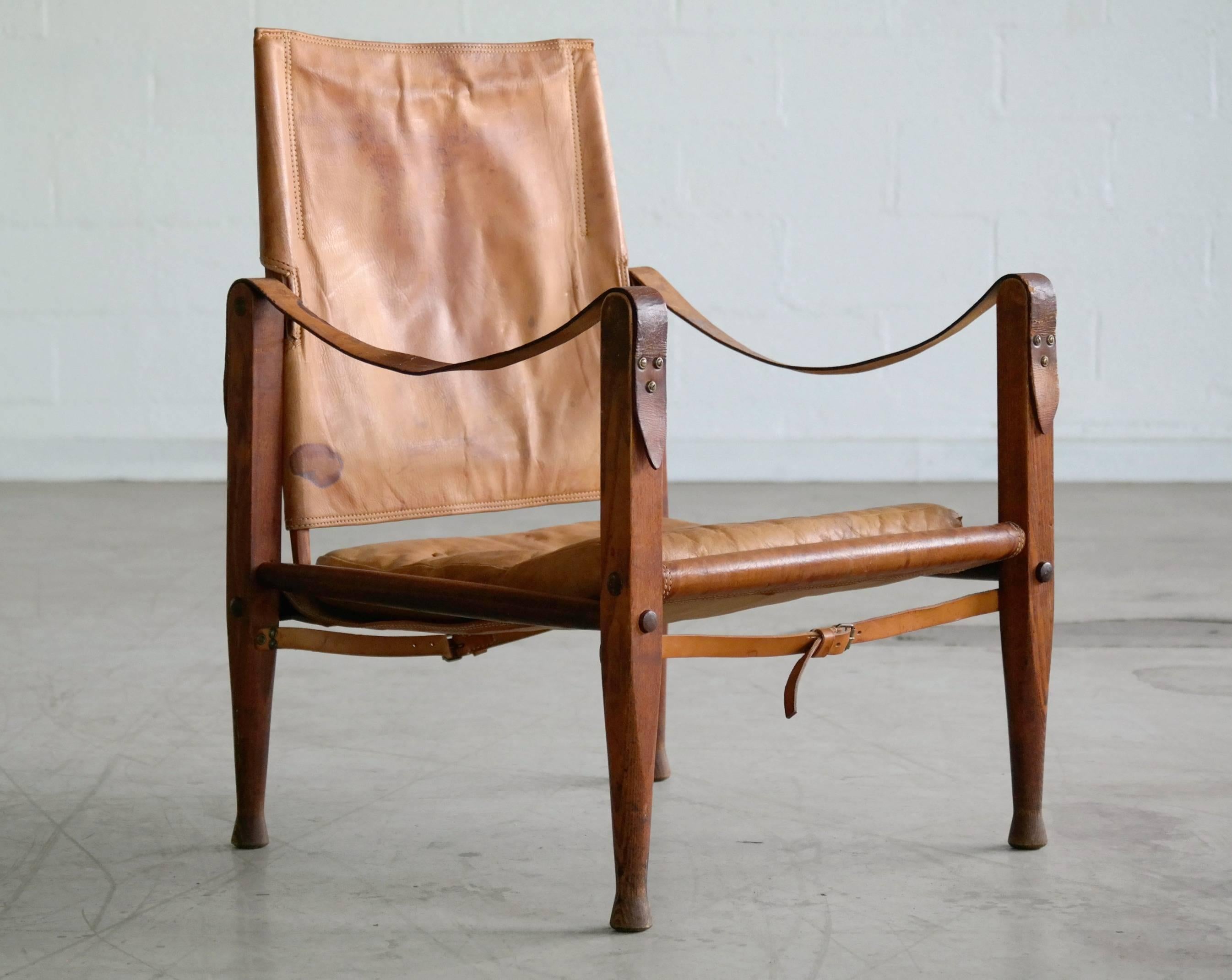 Fabulous original safari chair by the Godfather of all Danish Modern design and manufactured by one the most iconic Master Cabinet Makers. This iconic chair is in good condition. The cognac leather shows an absolute admirable patina and a strong