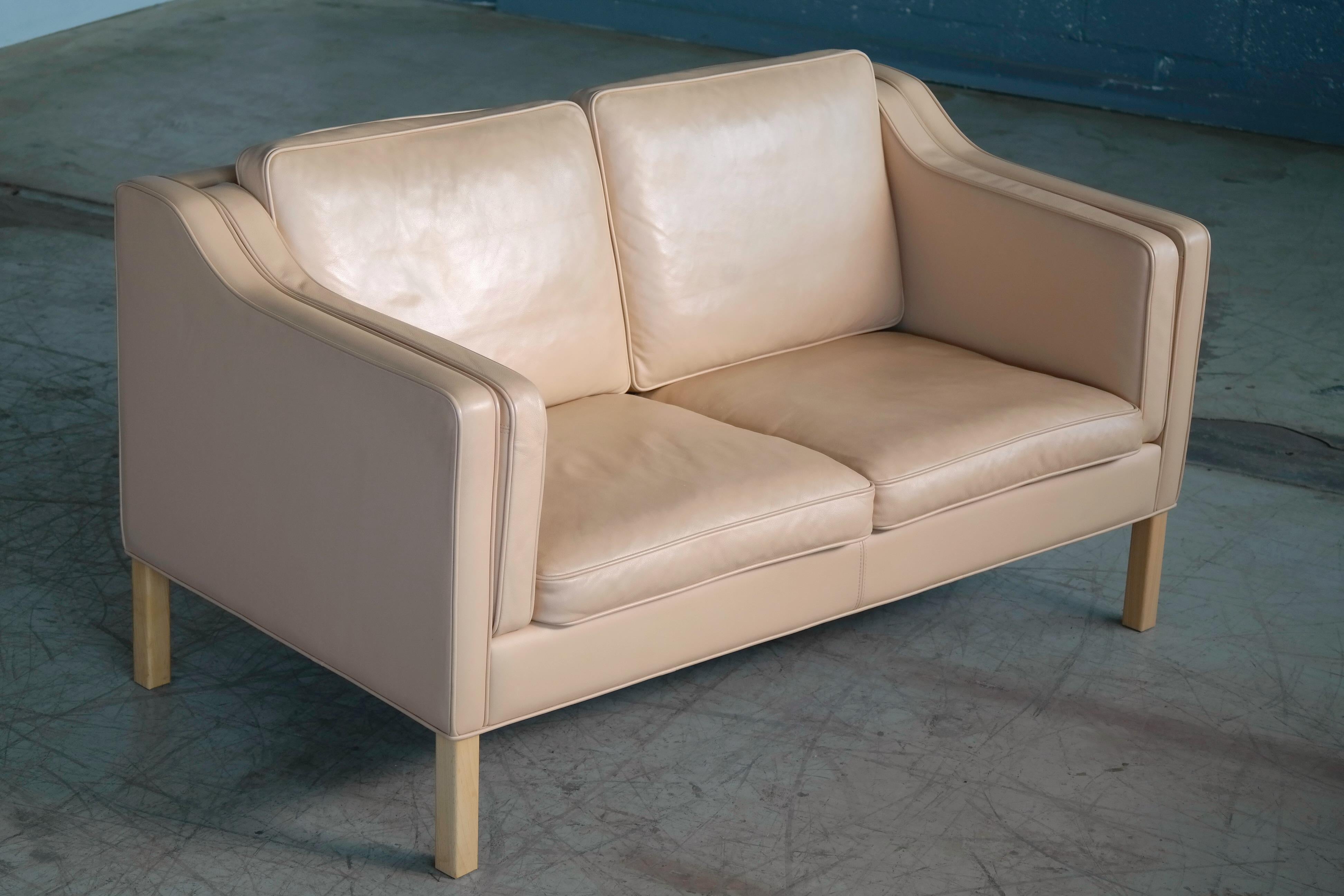 Classic Danish sofa set (3+2) in the style of Borge Mogensen's model 2212 and 2213. Executed in supple tan leather by Ryesberg Mobler raised on beech legs. Mogensen's Classic design has become a staple of modern decor as his sofas set a new standard