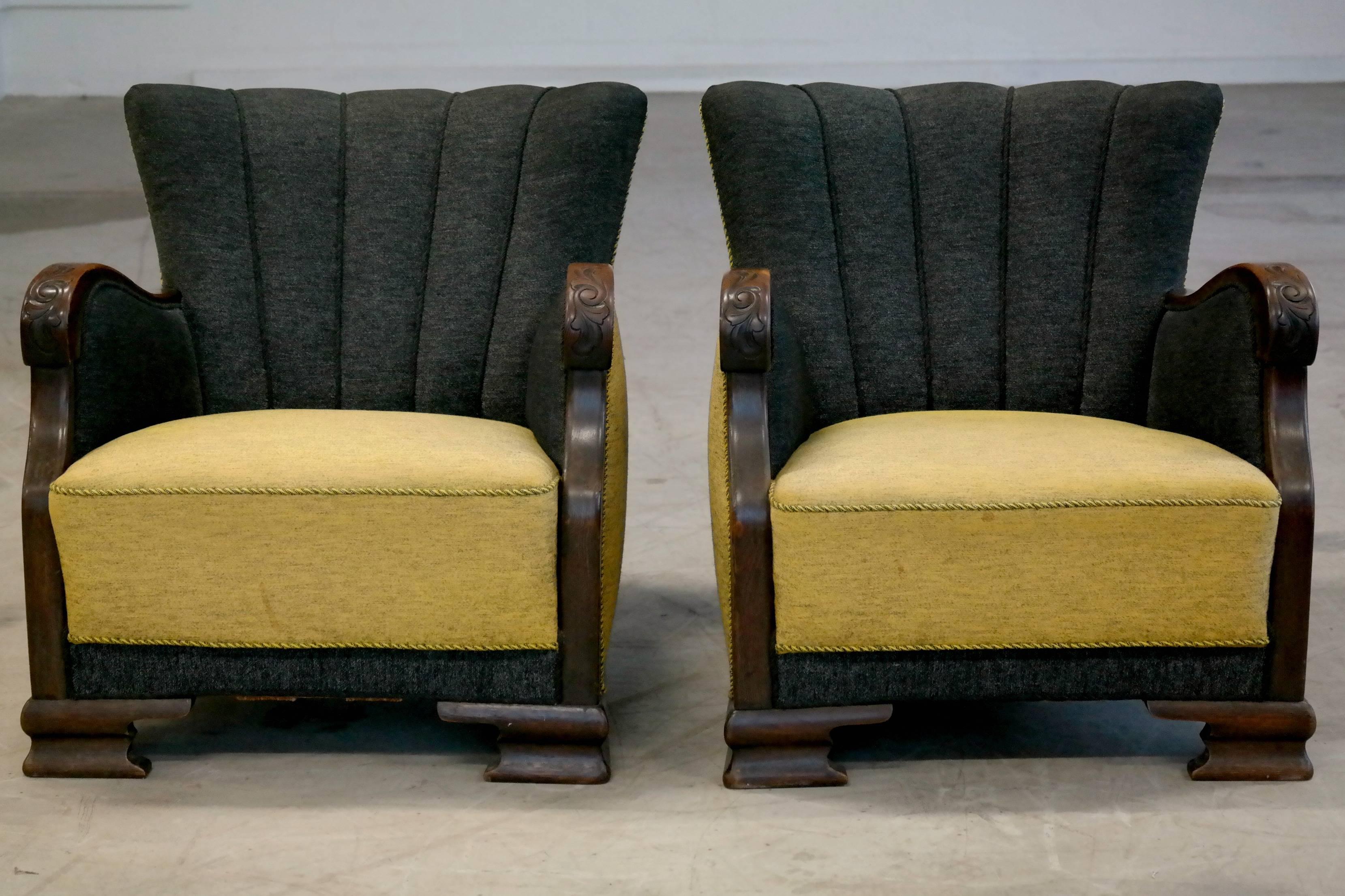 Beautiful Danish made early Mid-Century club chairs. Beautifully hand-carved armrests in mahogany. Still has original fabric and all its old-world charm.