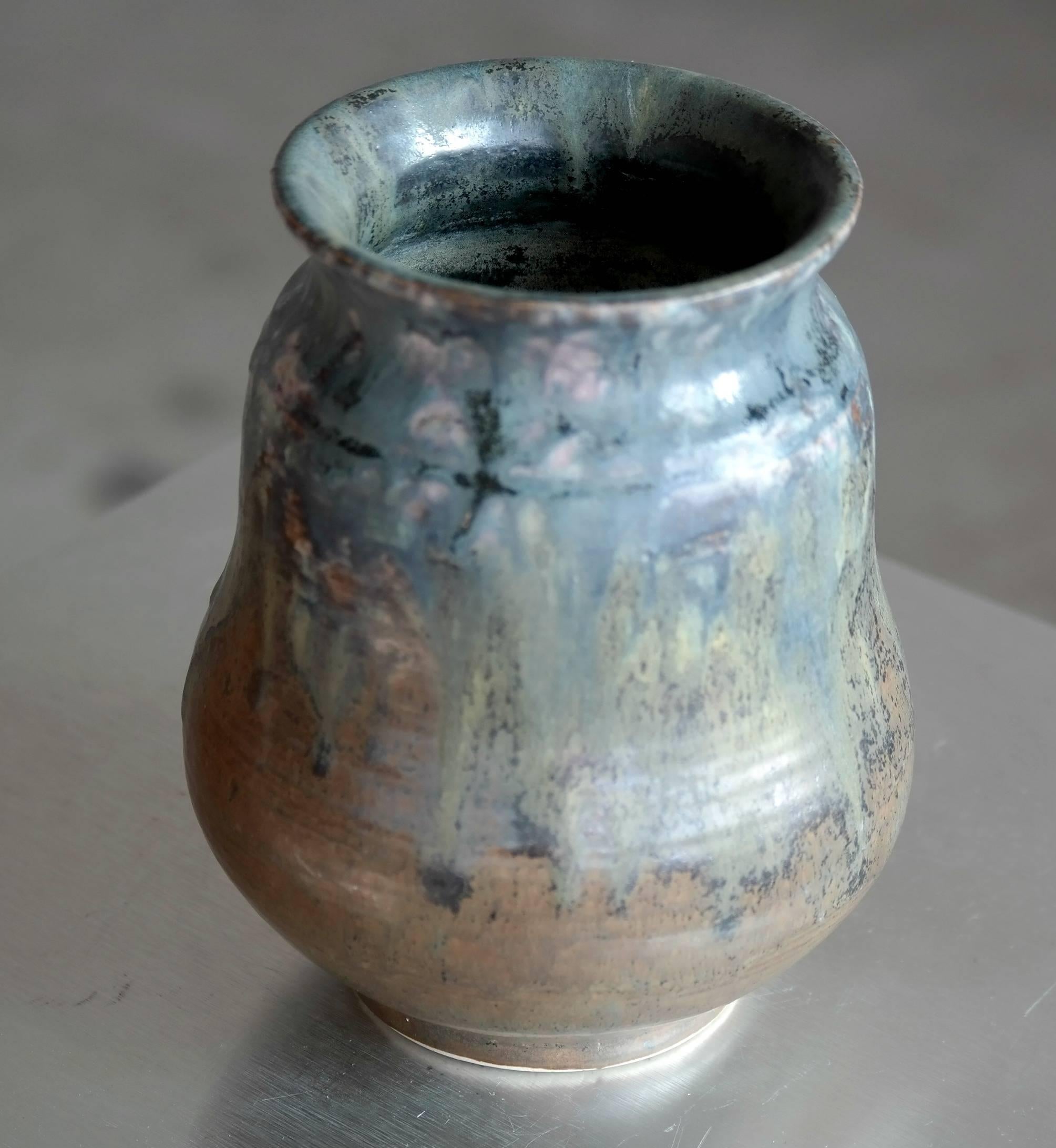 Unique stoneware vase with streaky bluish green crystalline glaze with traces of pink by Carl Halier. Halier shared studio with Arne Bang and Axel Salto in the late 1920s when this vase was made.

