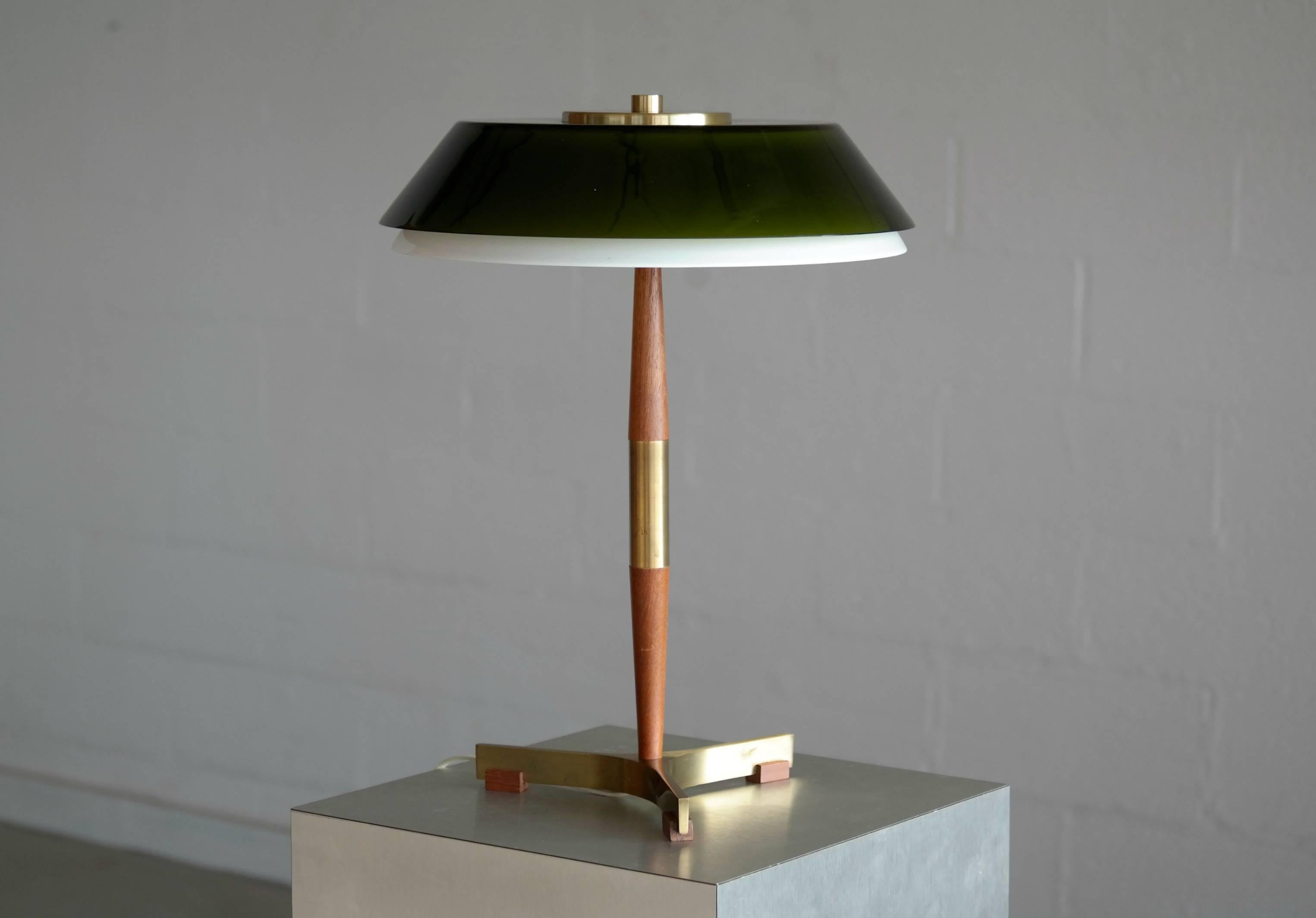 Iconic table Lamp by Jo Hammerborg model president in teak and brass with glass shades made by Fog & Mørup, Denmark. This model with a two-tier shade in glass is quite rare and few have survived with the glass intact.